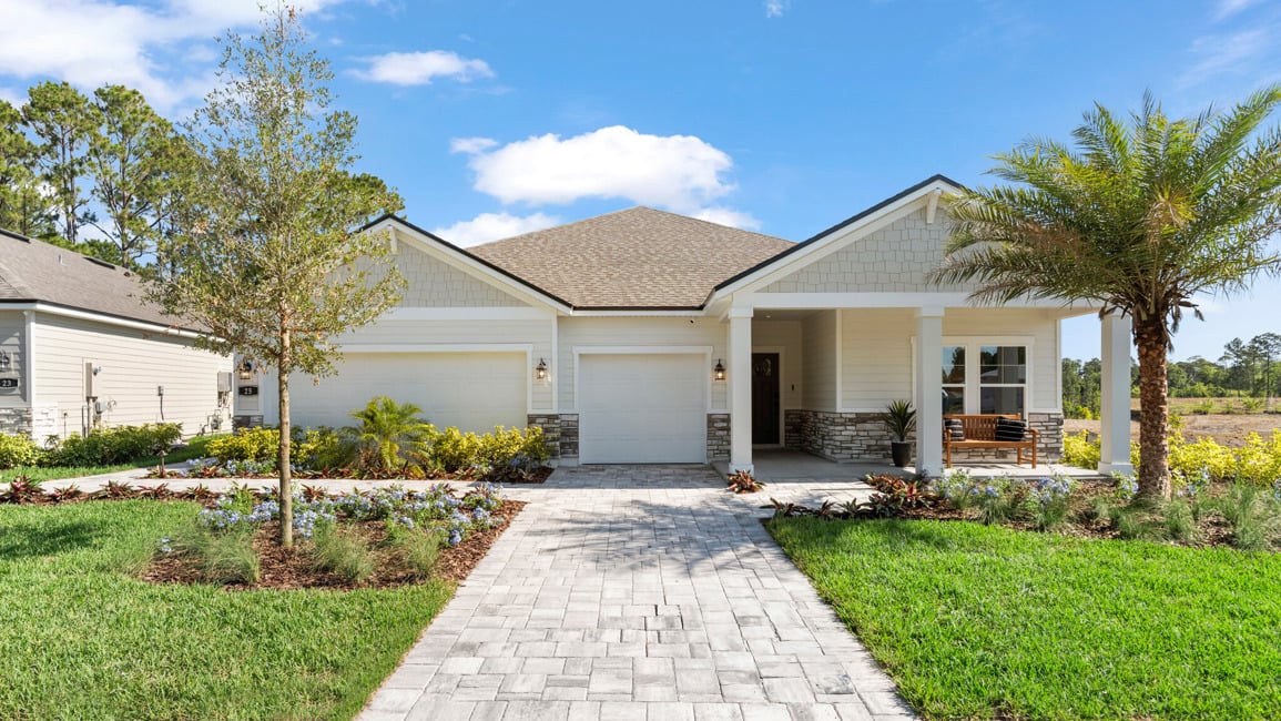 Kenai Model Home Exterior with 3 Bay Garage and Coastal Landscaping at Reserve East in Flagler Beach