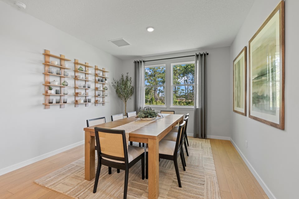 Kenai Model Home Dining Room with Large Table and Eight Chairs at Reserve East in Flagler Beach