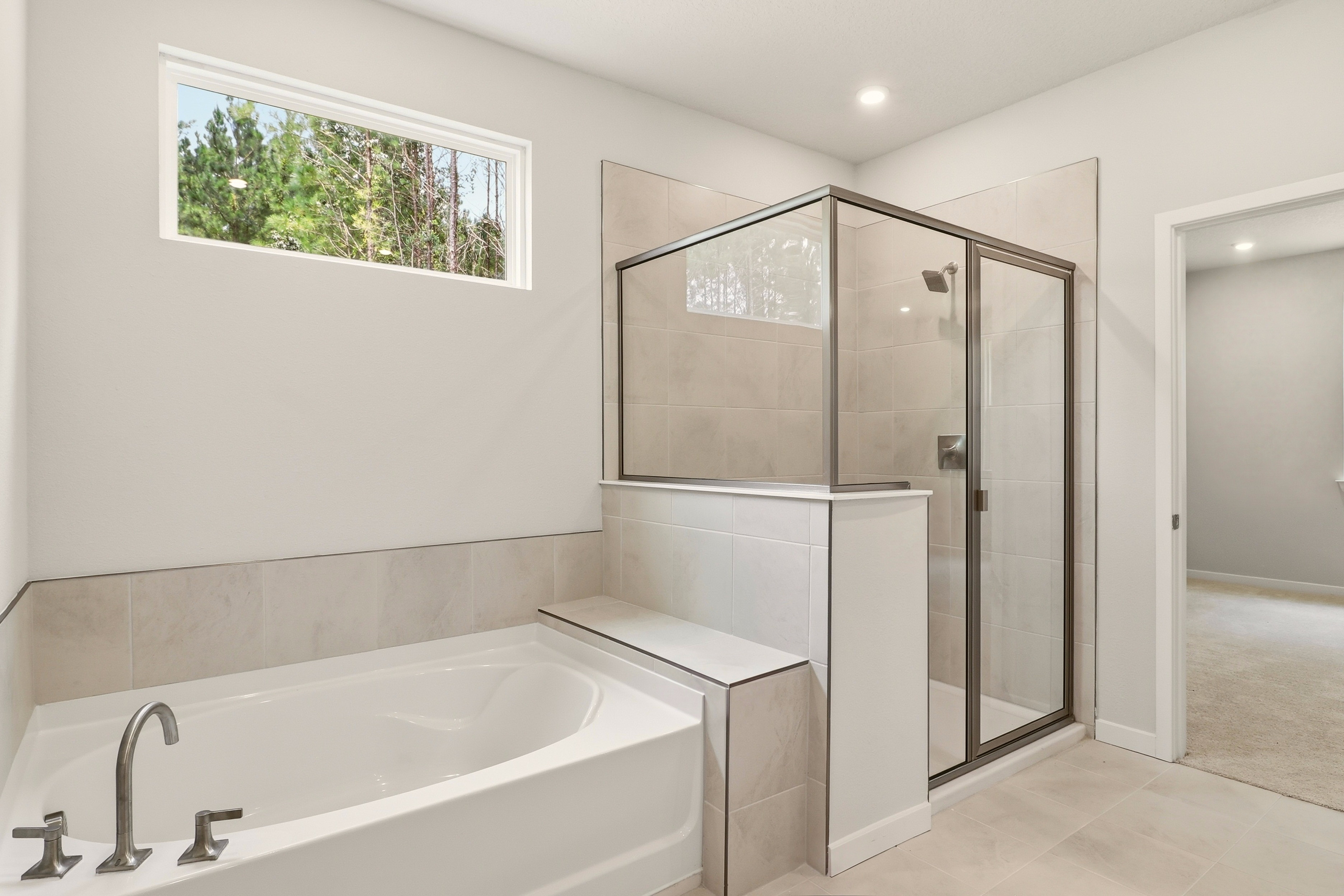 A bathroom with a tub and shower.