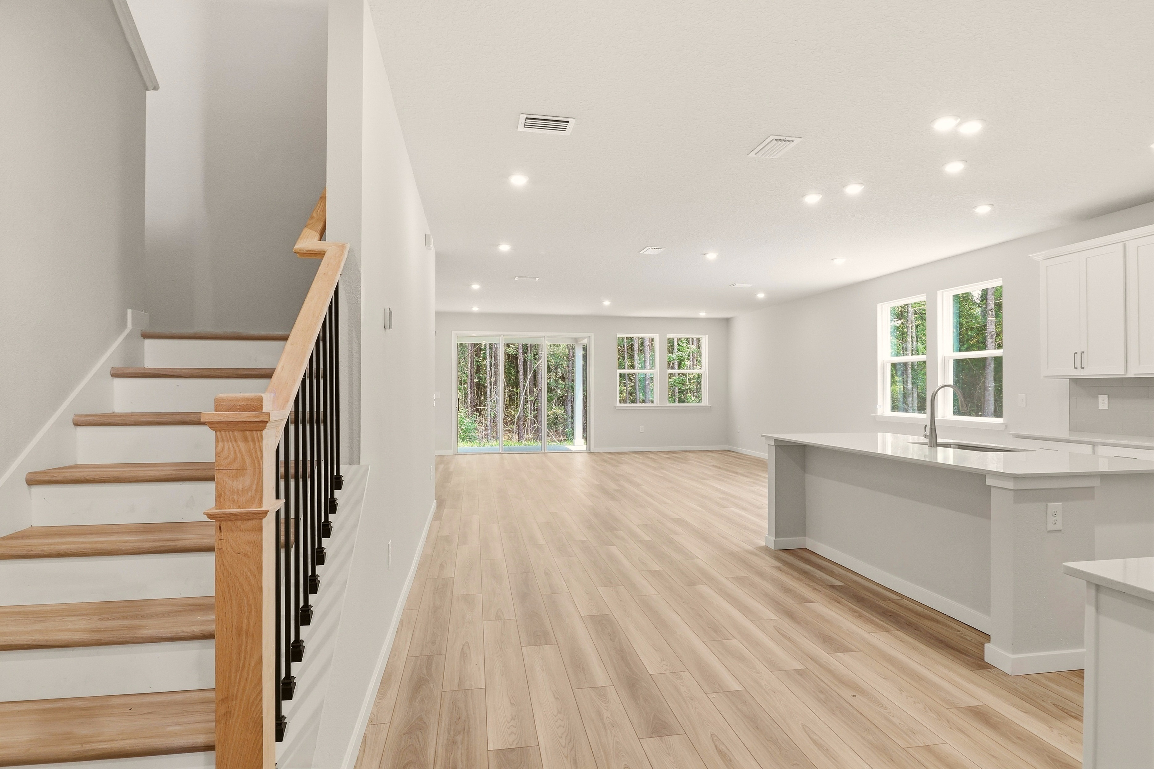A large white room with wooden floors.
