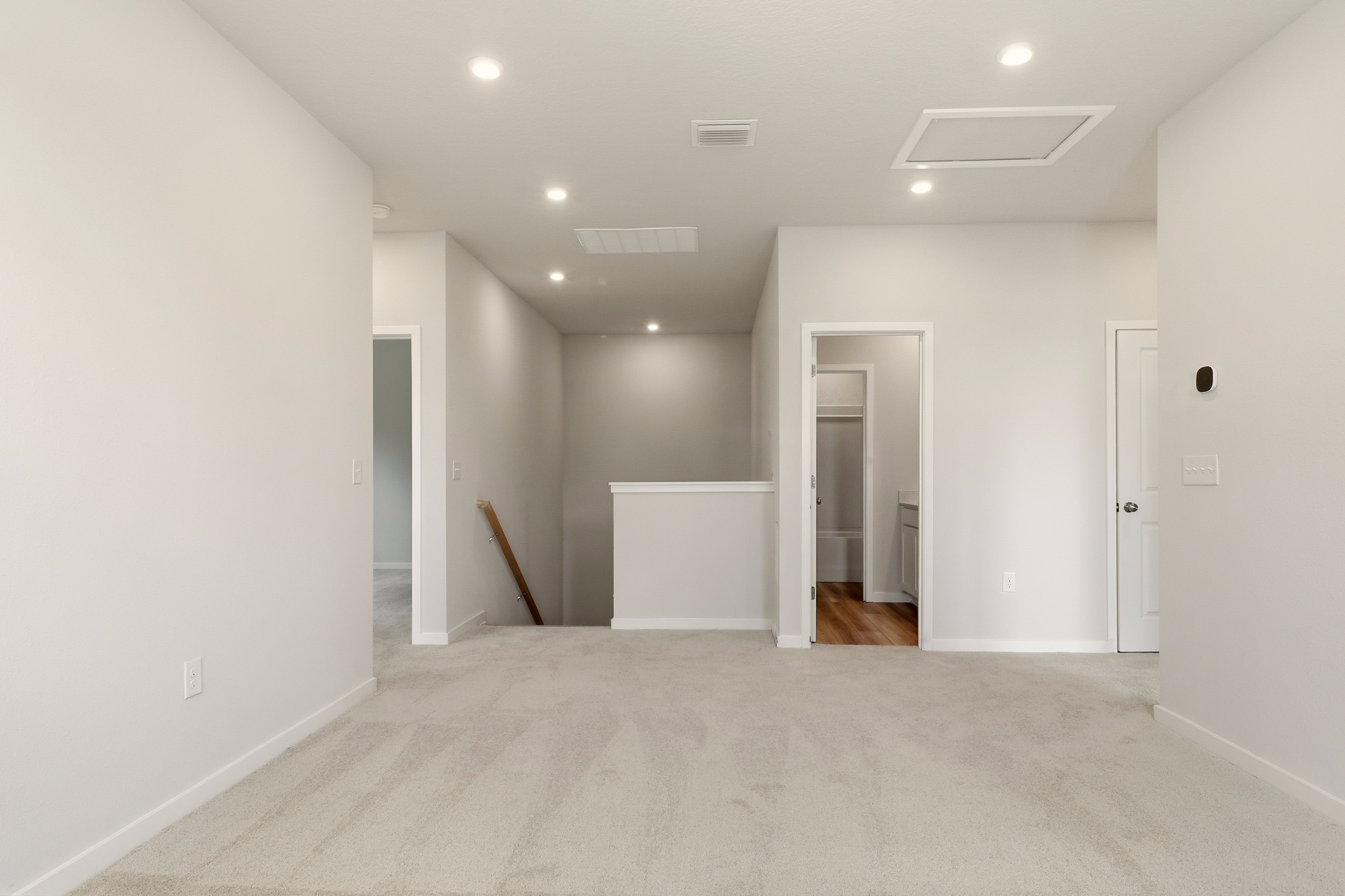 A hallway with white walls.