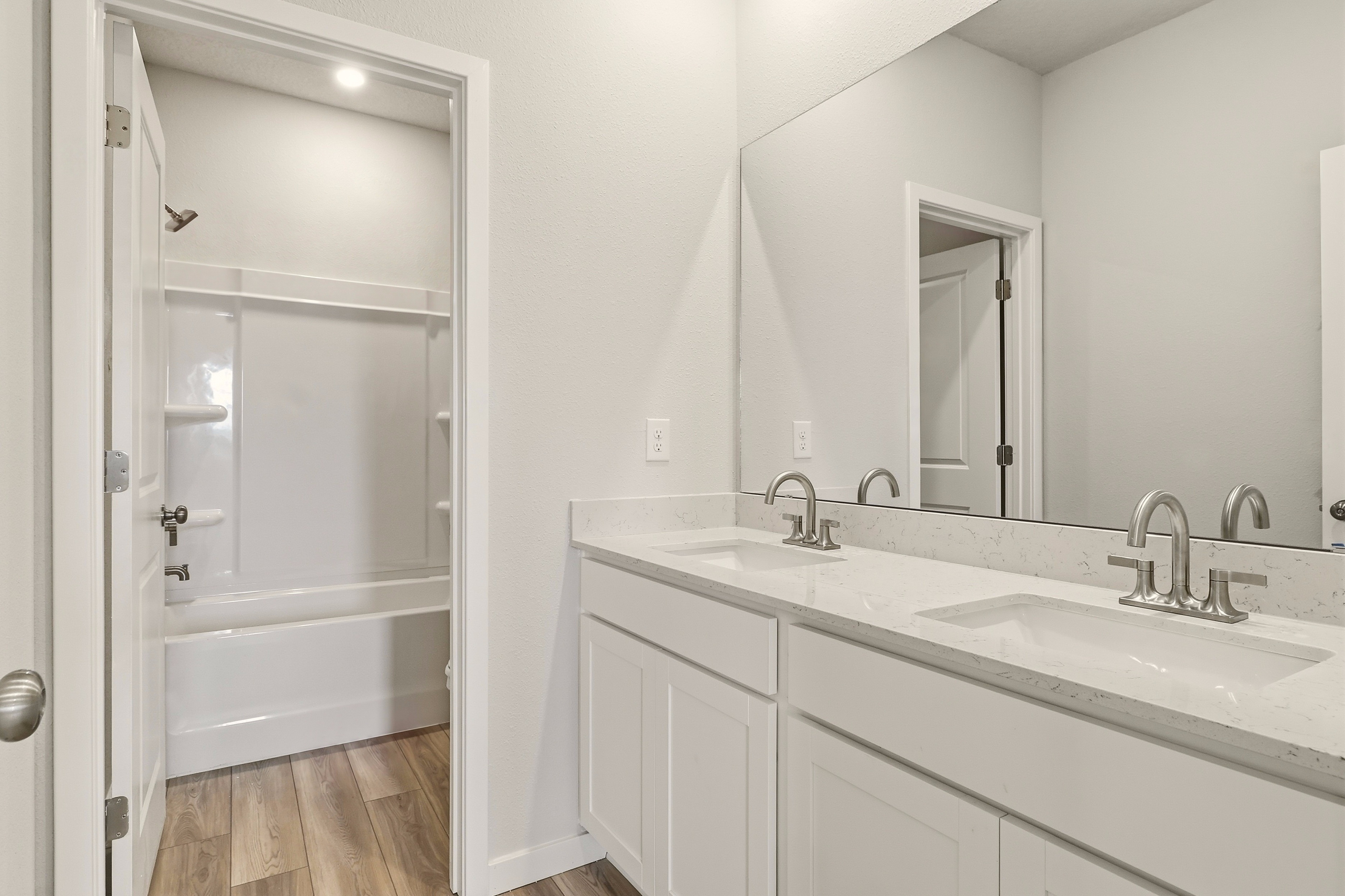 A bathroom with a sink and a mirror.