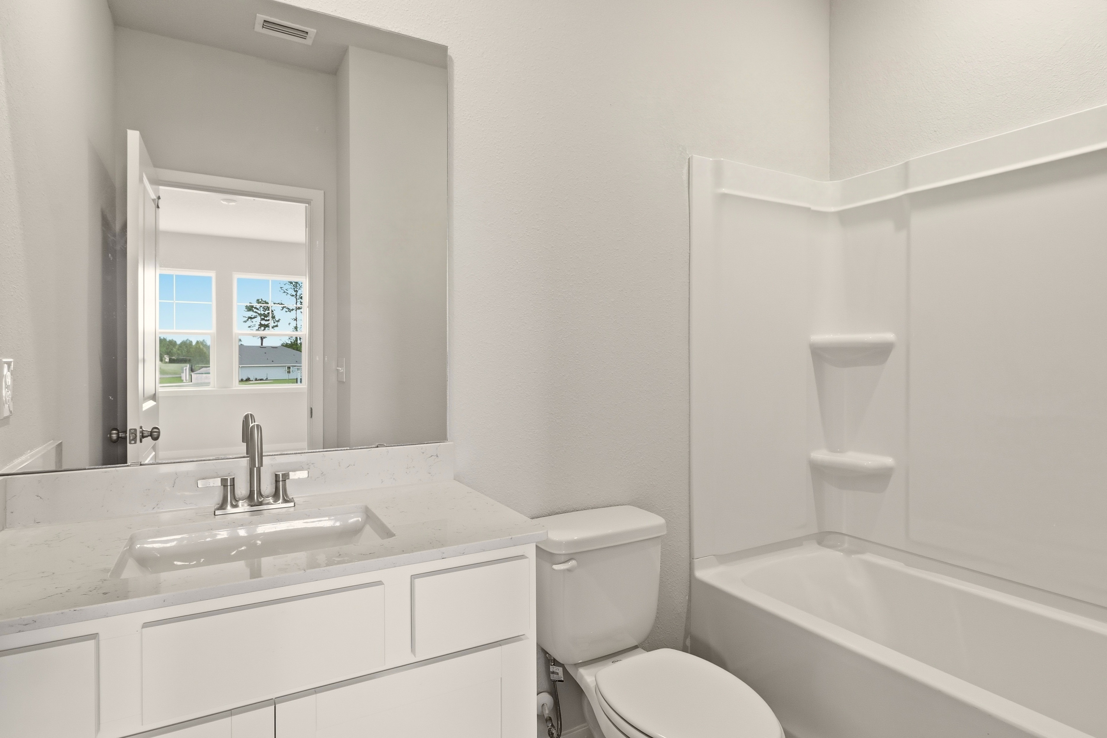 A bathroom with a tub sink and toilet.