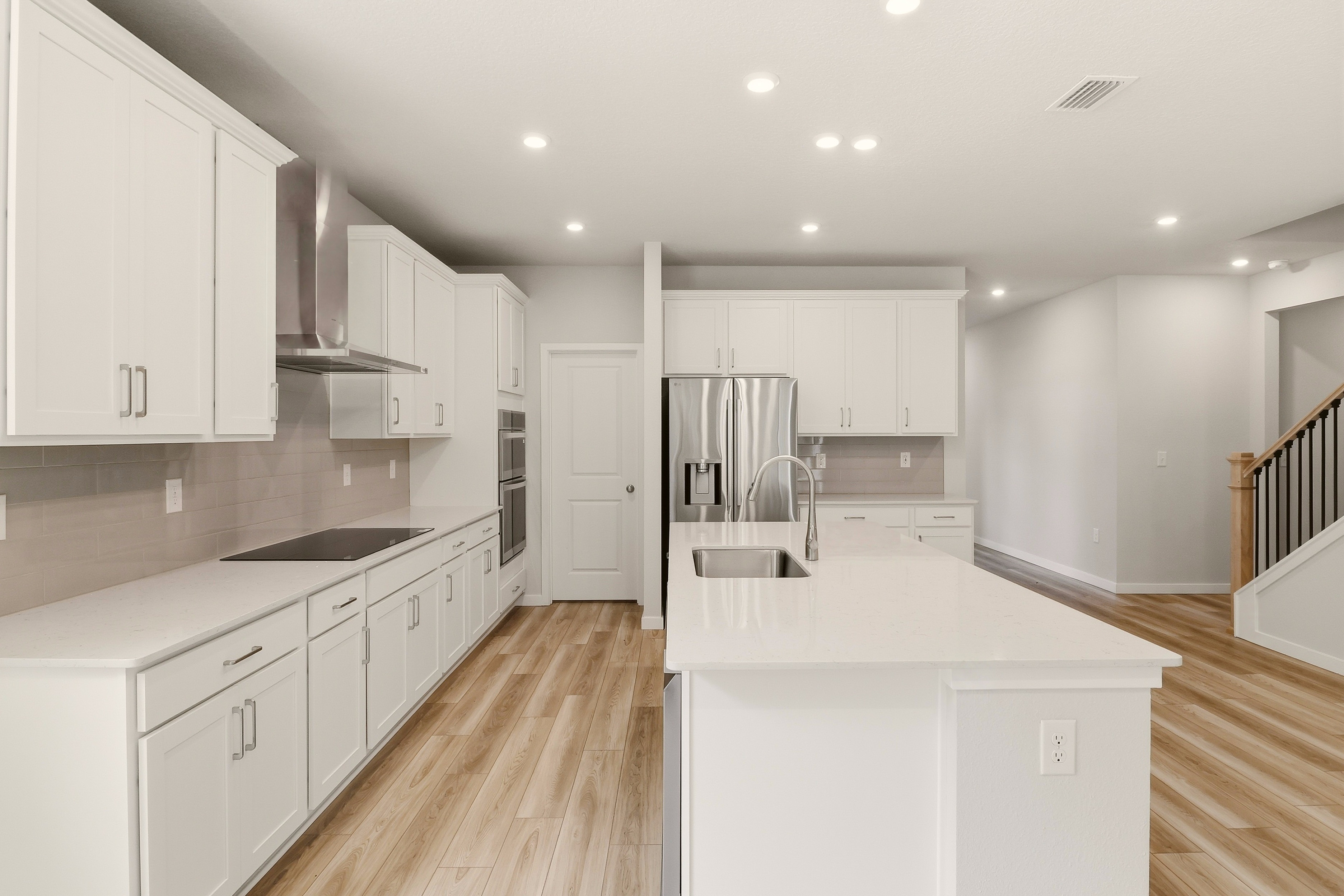 A kitchen with white cabinets.