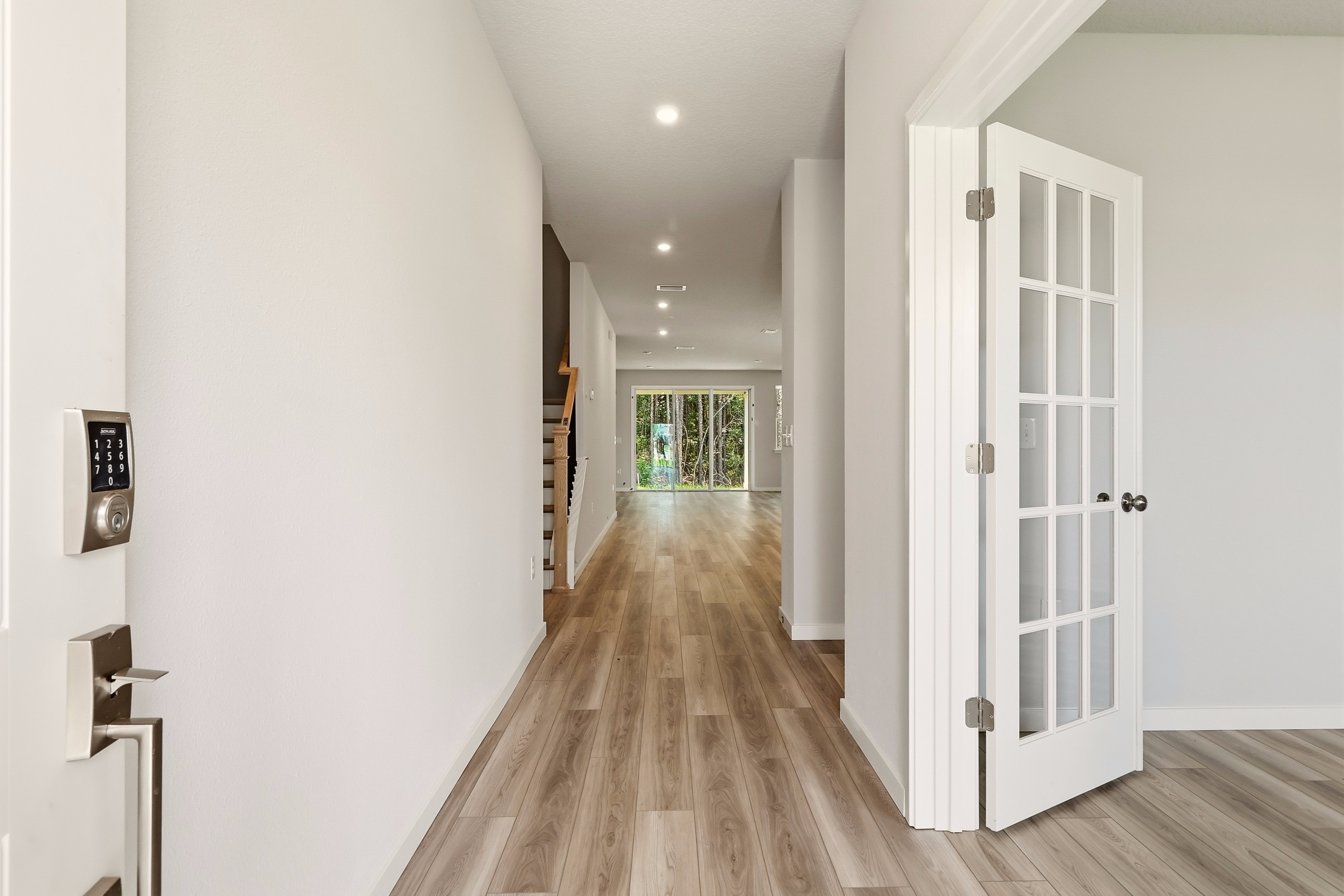 A hallway with white doors.