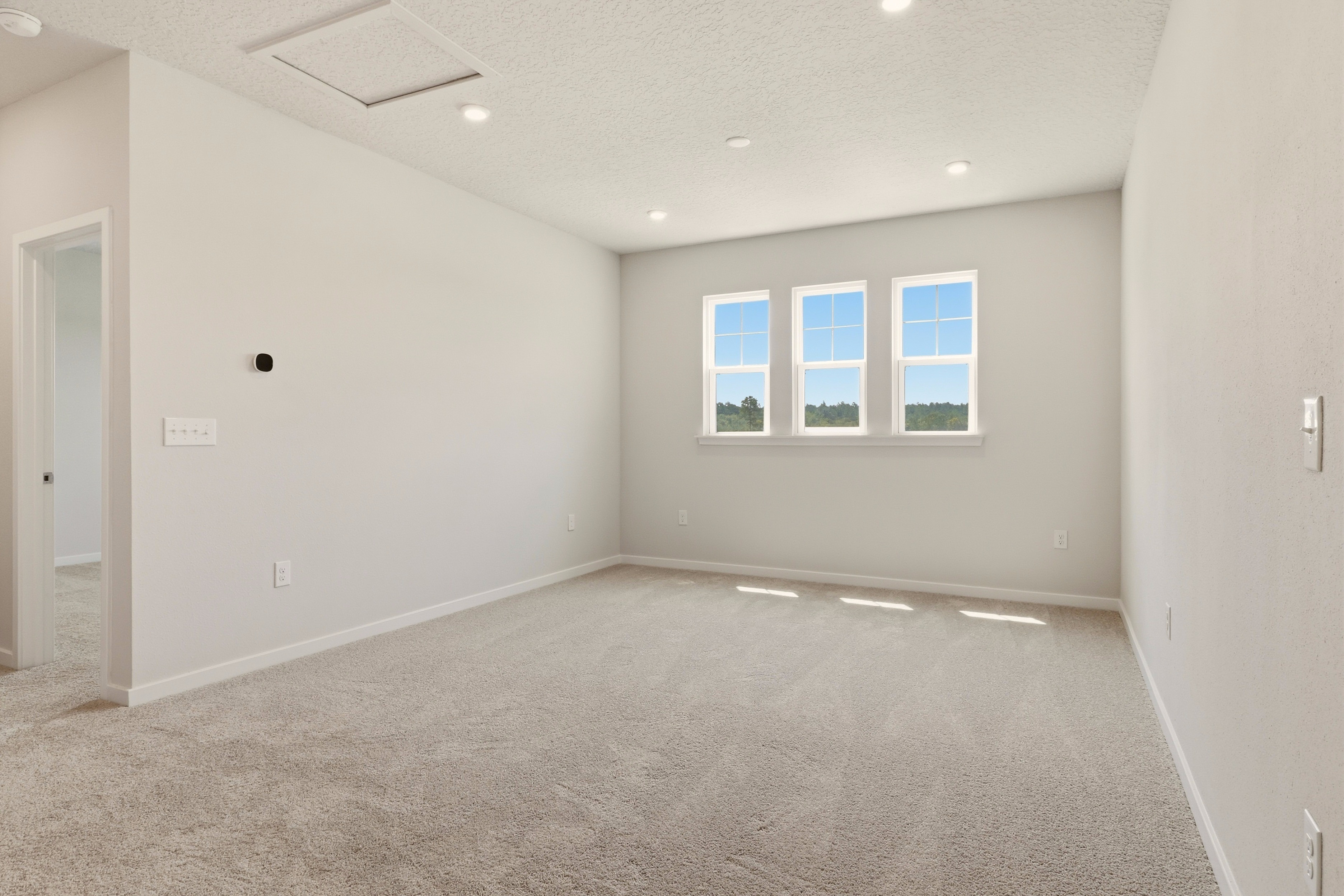 A room with a window and a door.