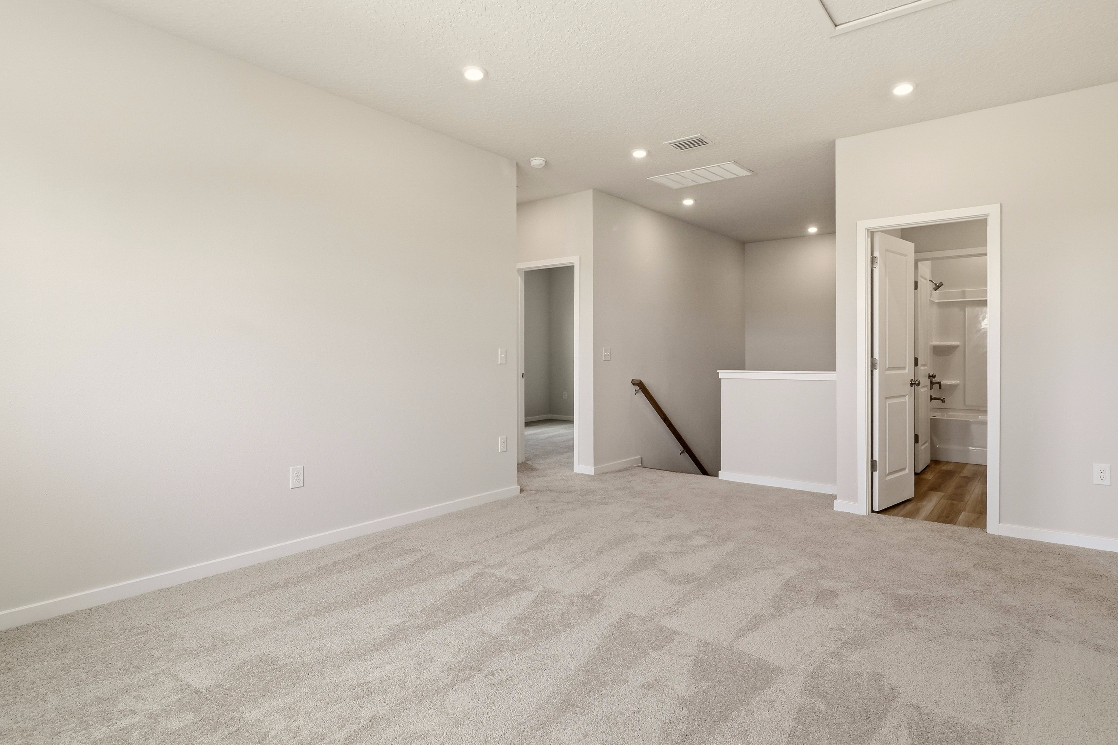 A room with a carpet and a broom in it.