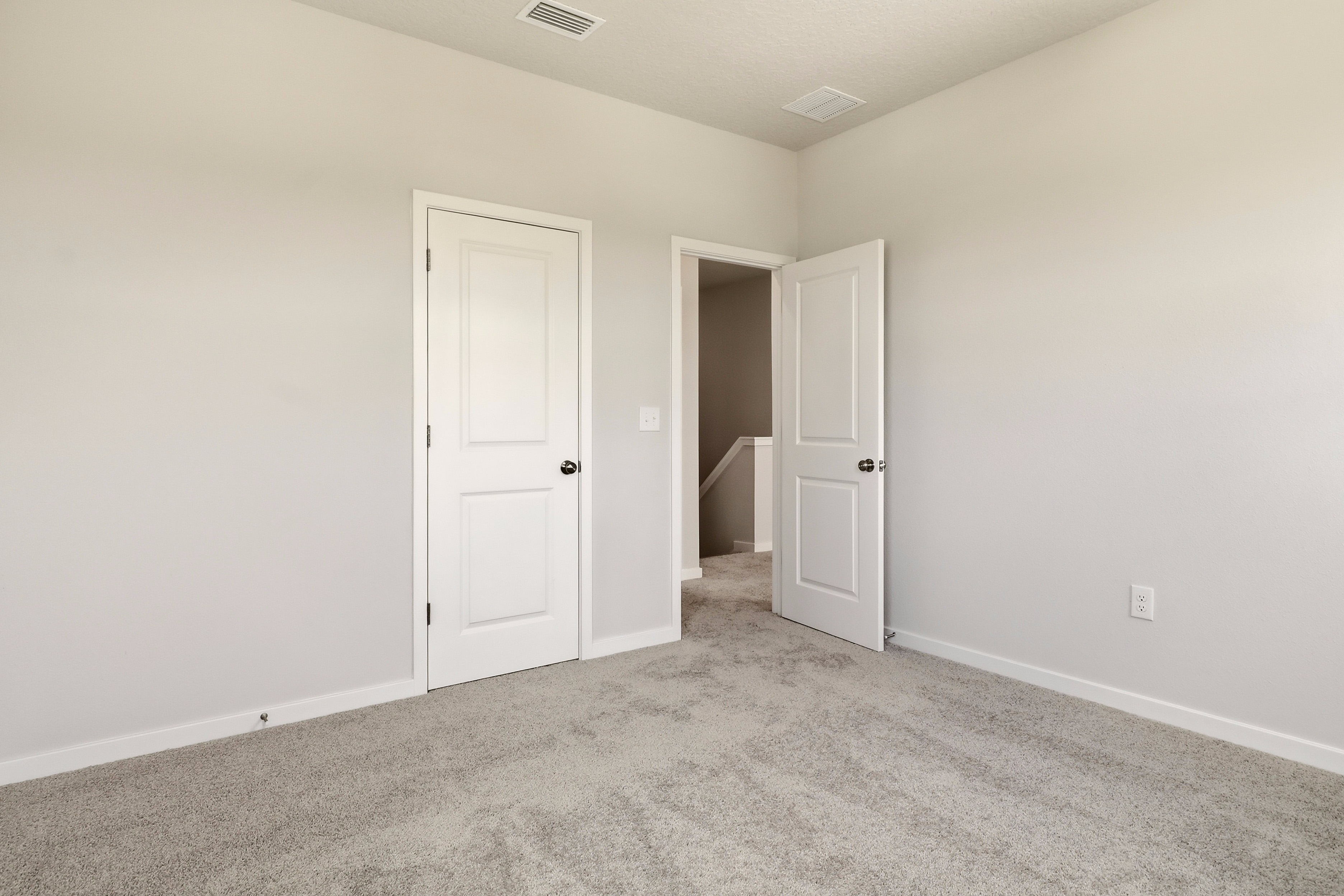 A hallway with white doors.