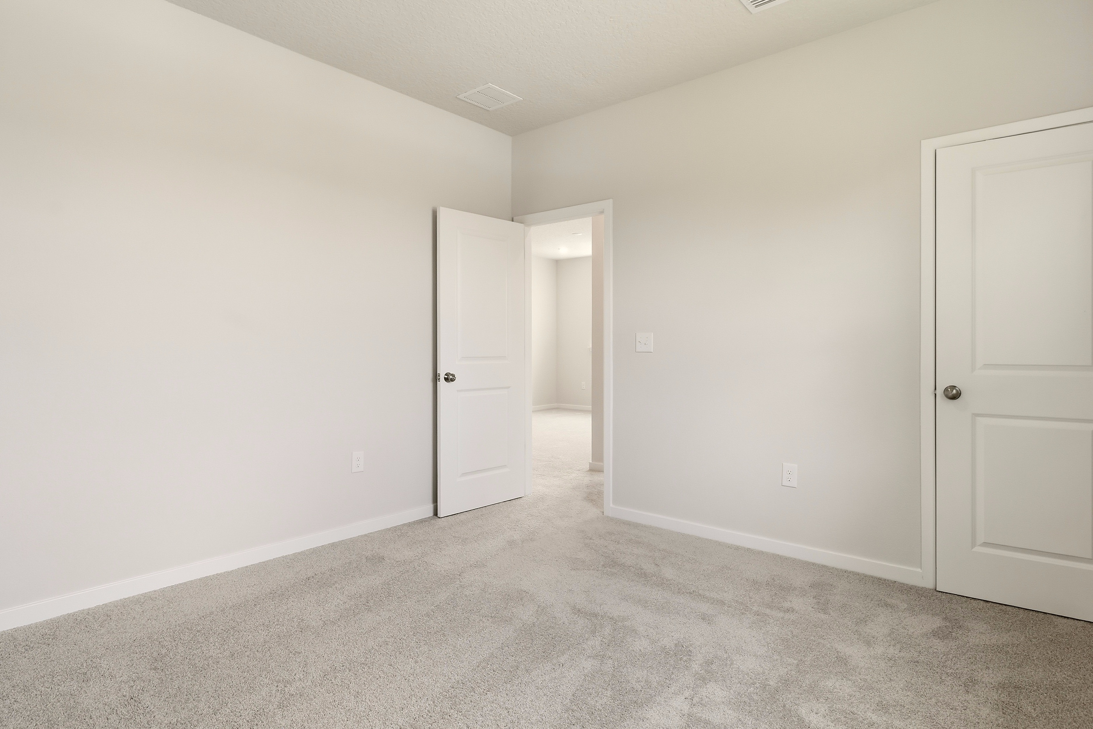A hallway with white doors.