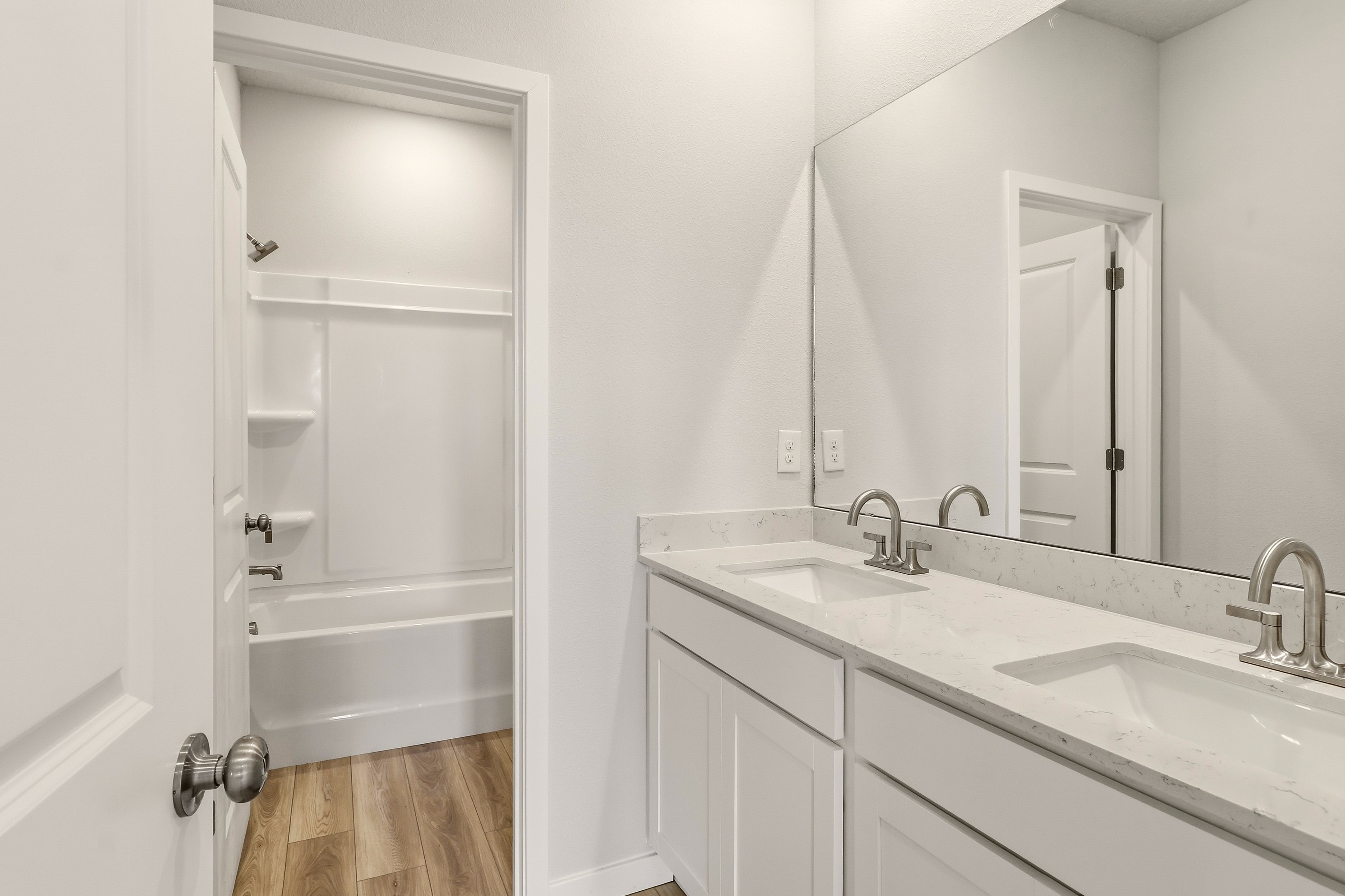 A bathroom with a sink and a mirror.
