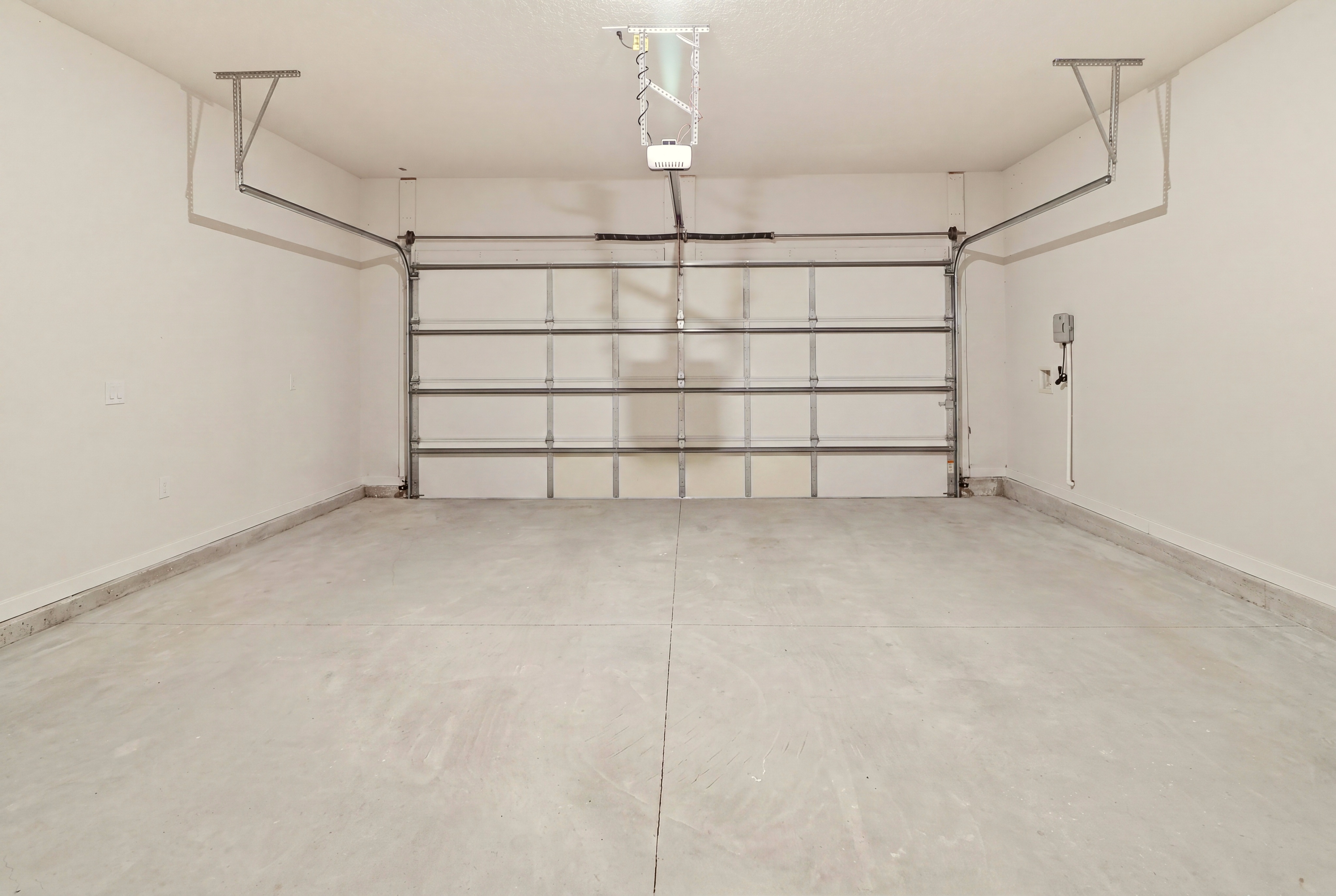 A white room with a metal gate.