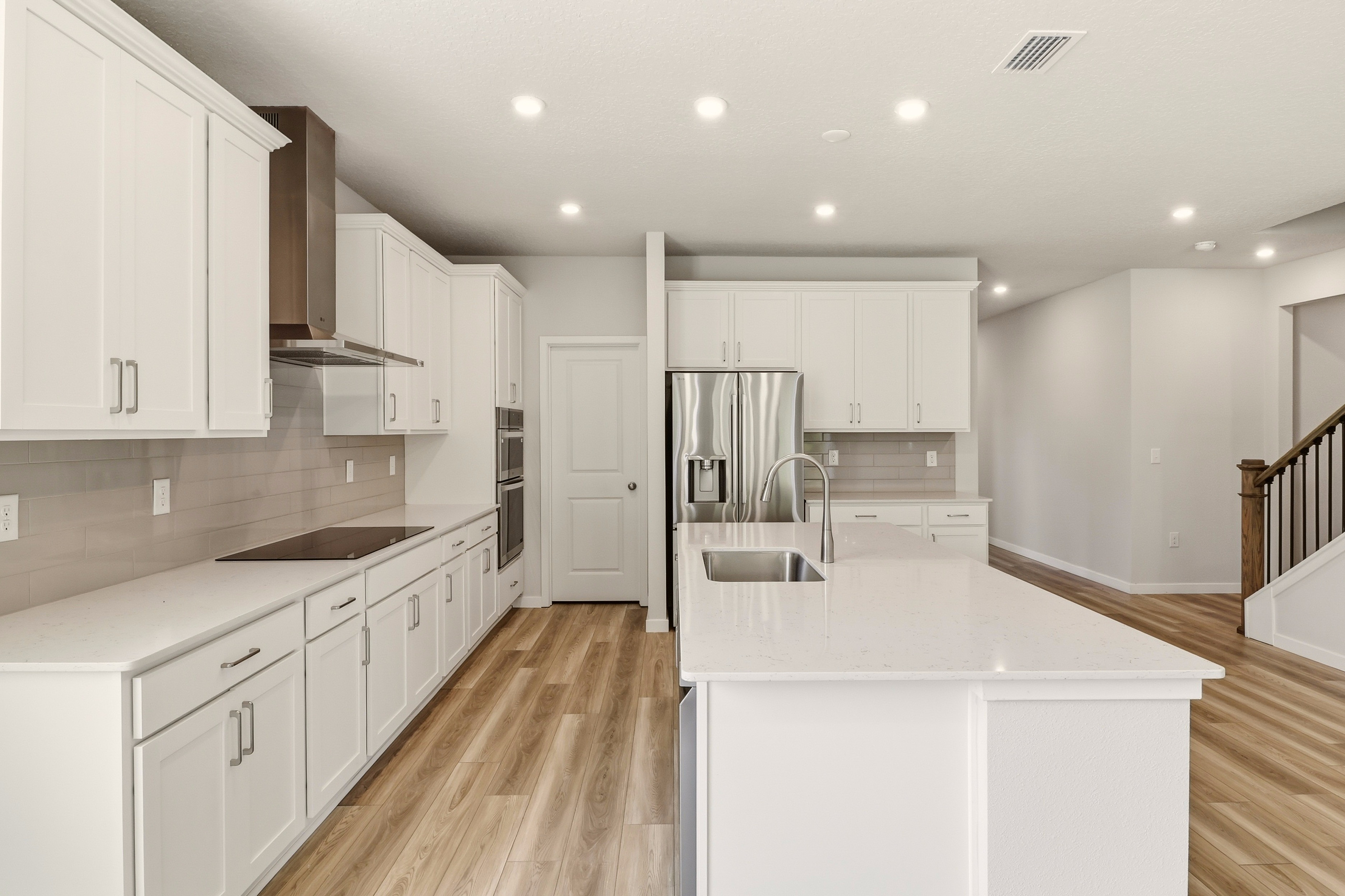 A kitchen with white cabinets.