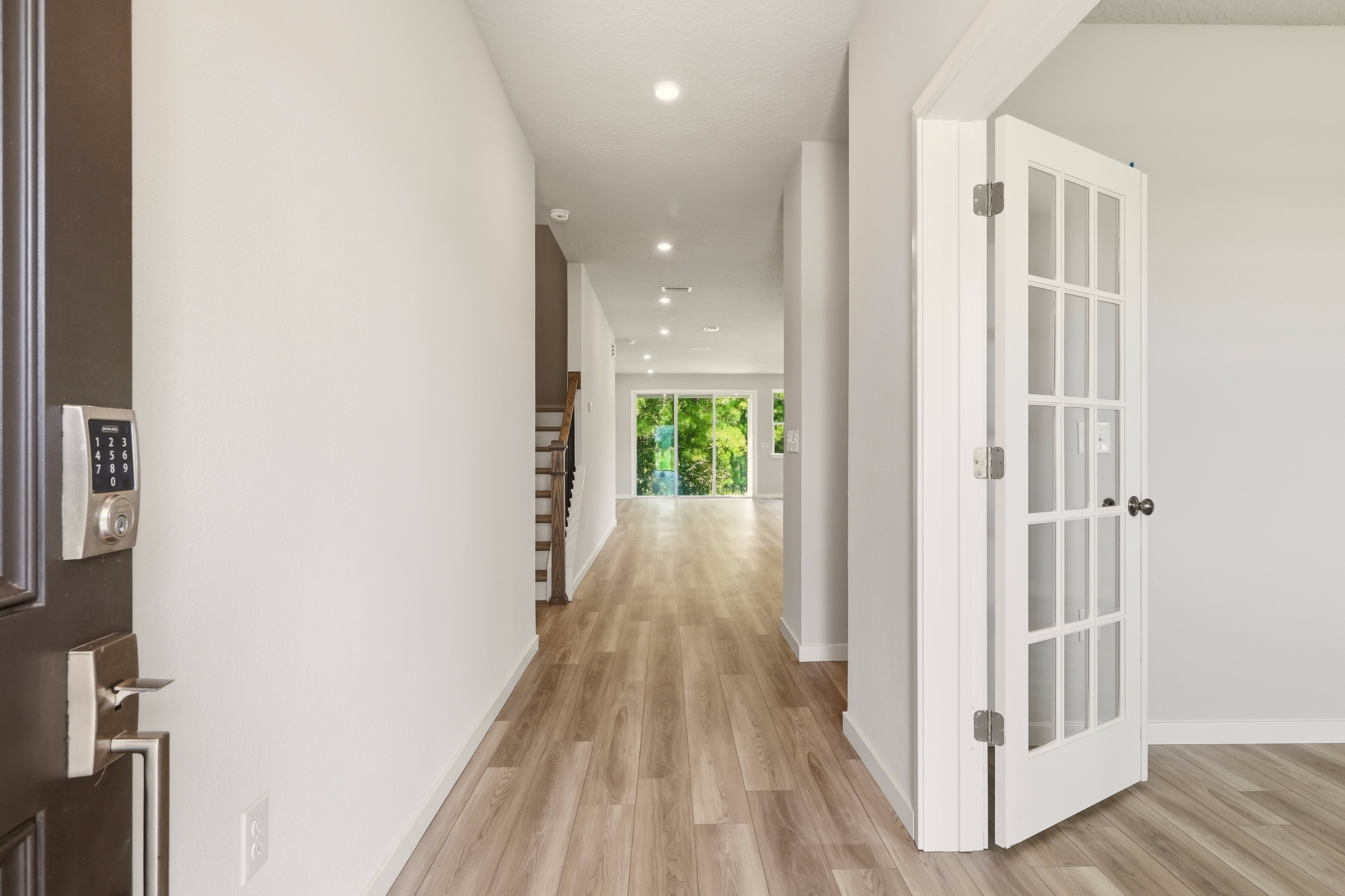A hallway with white doors.