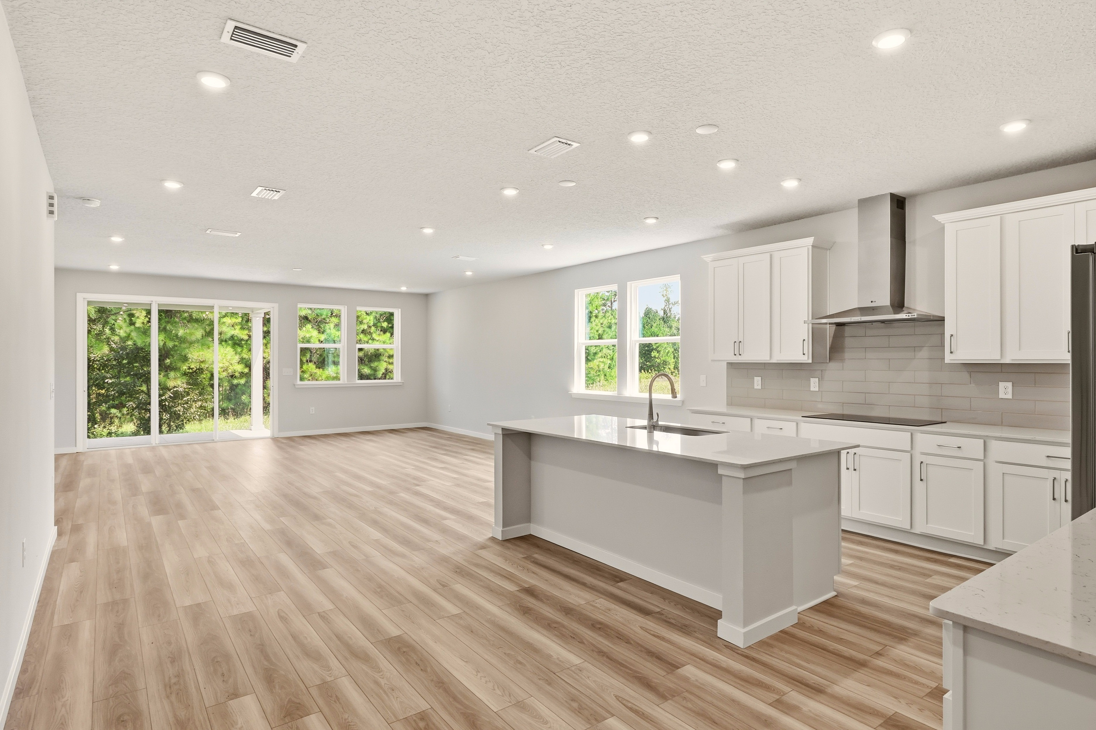 A kitchen with white cabinets.