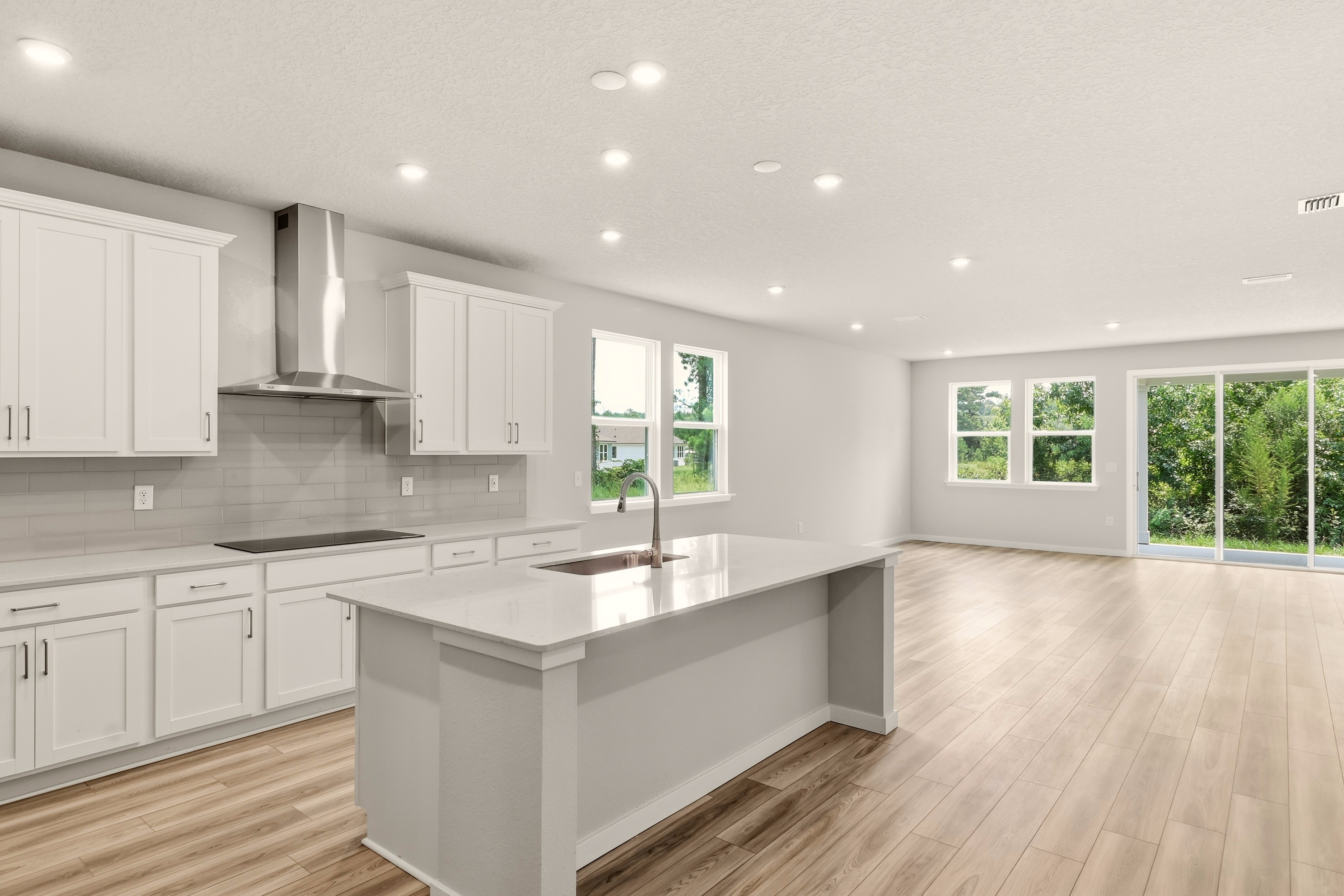 A kitchen with white cabinets.