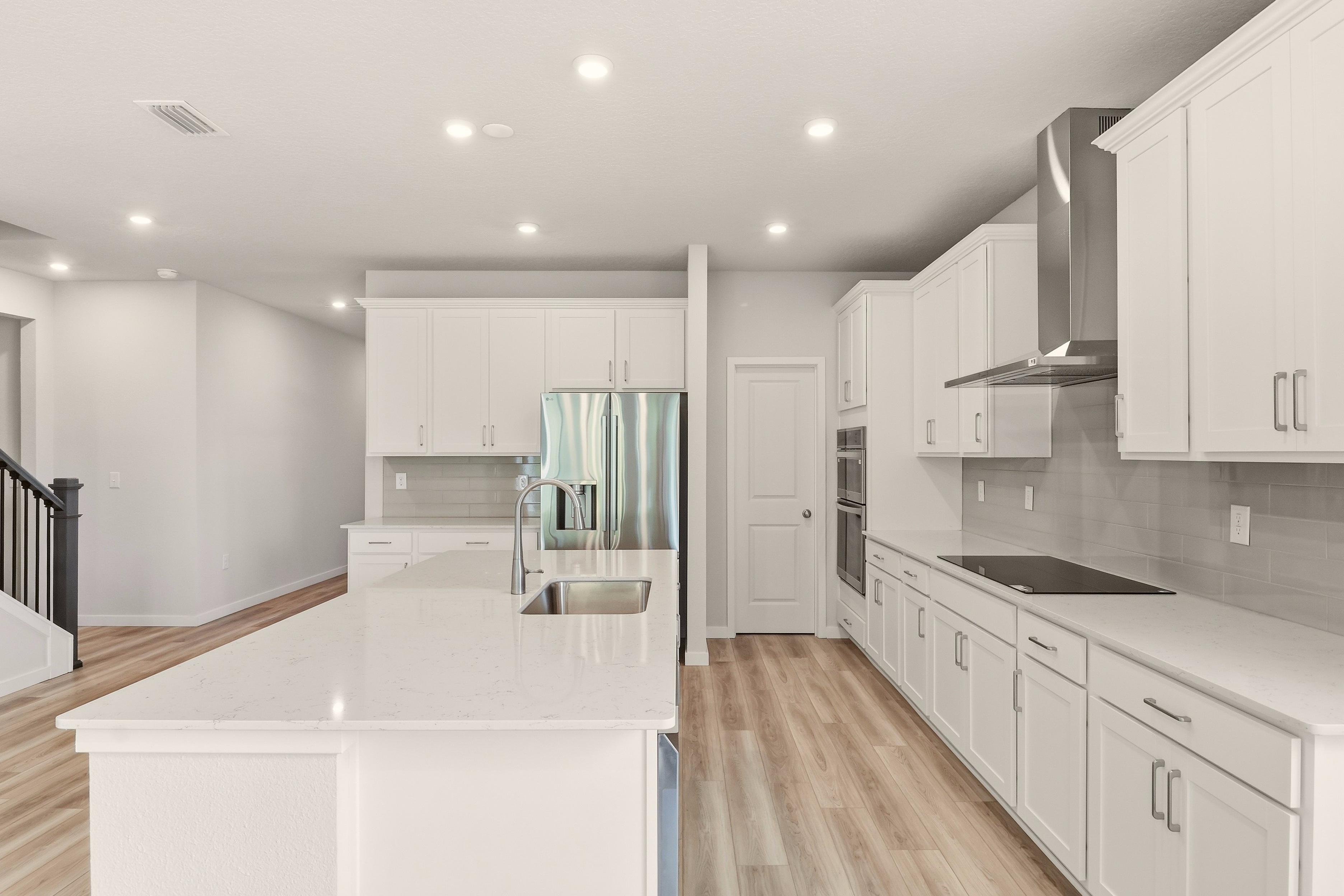 A kitchen with white cabinets.