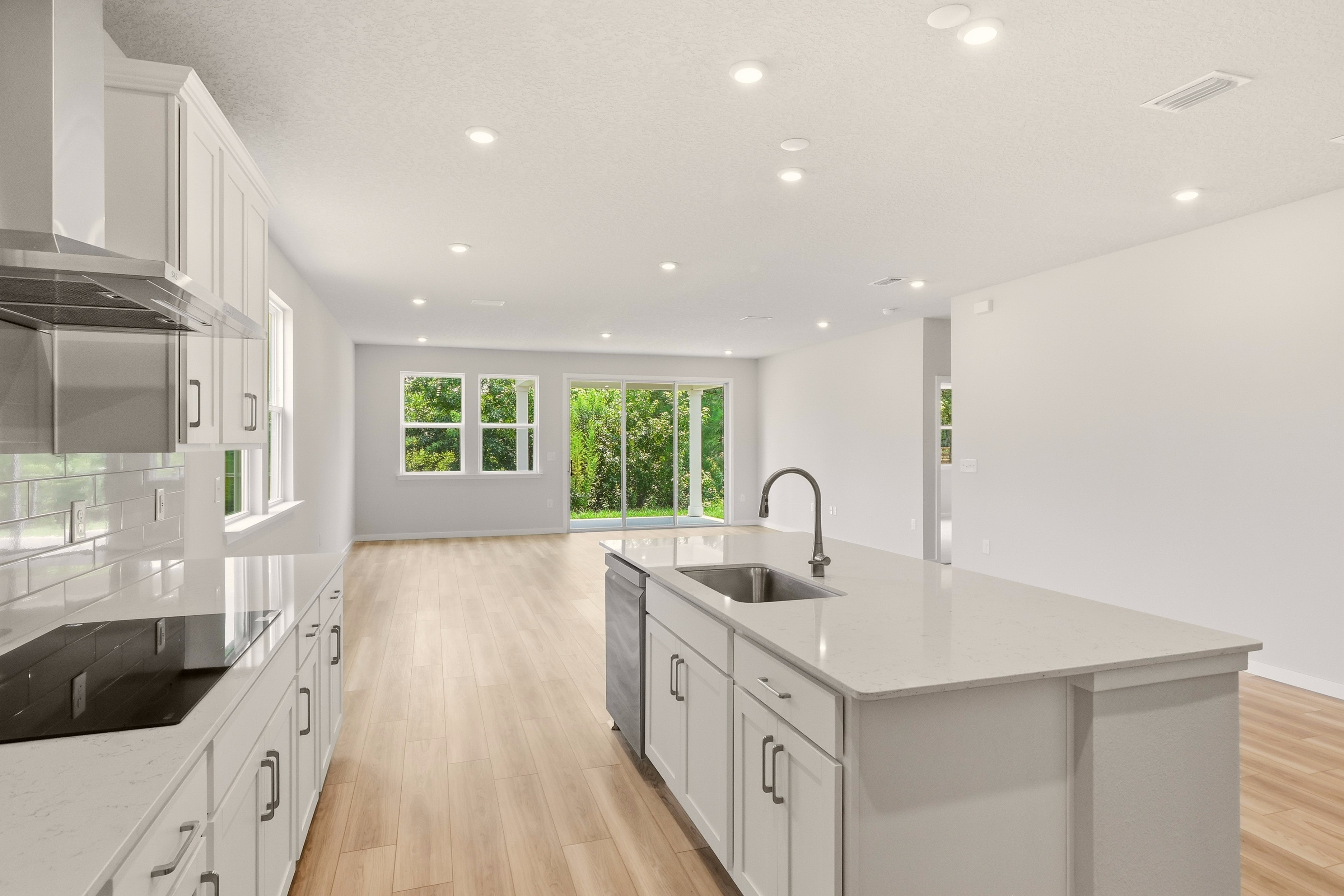 A kitchen with white cabinets.