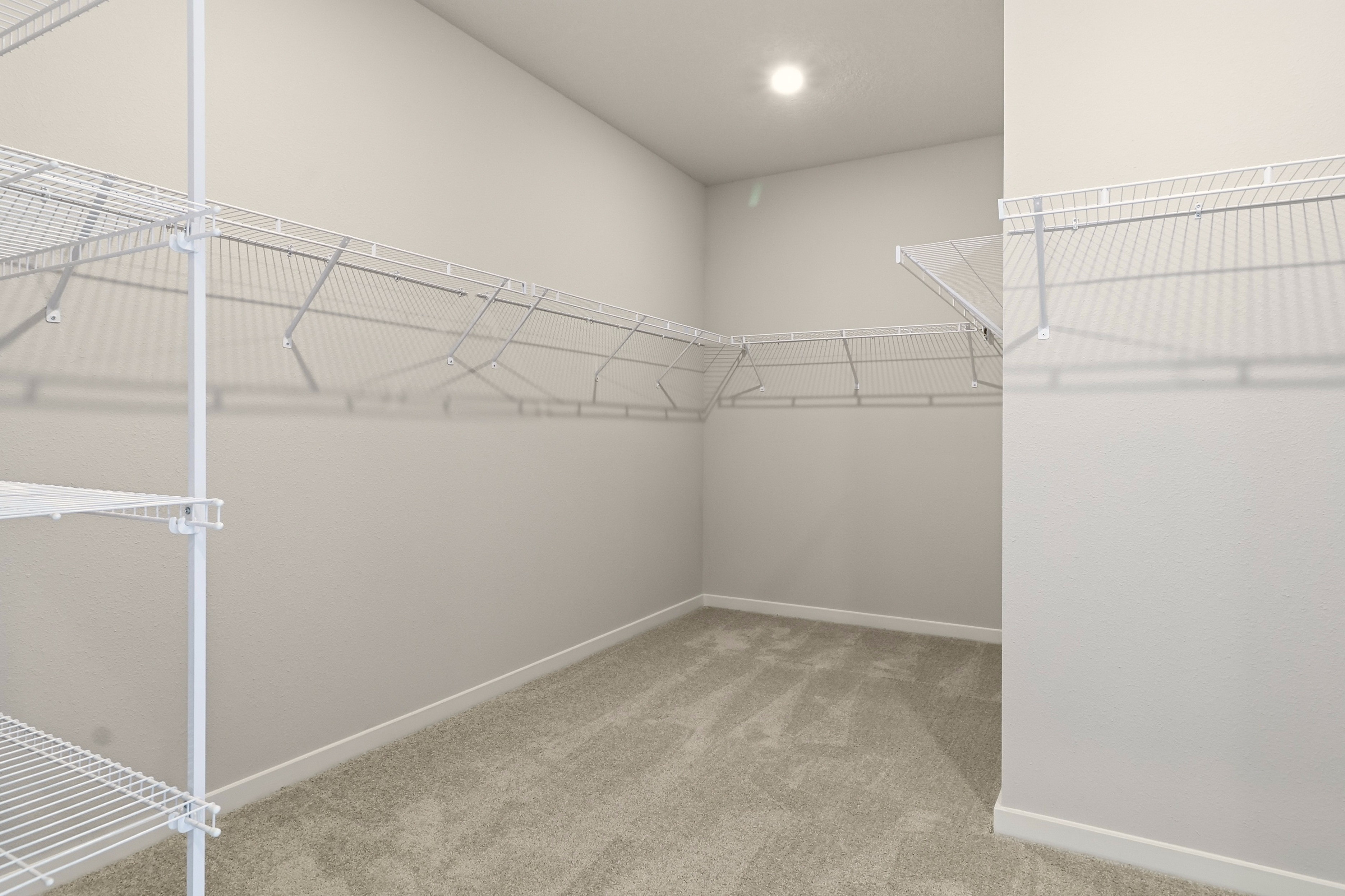 A room with a white wall and a metal railing.
