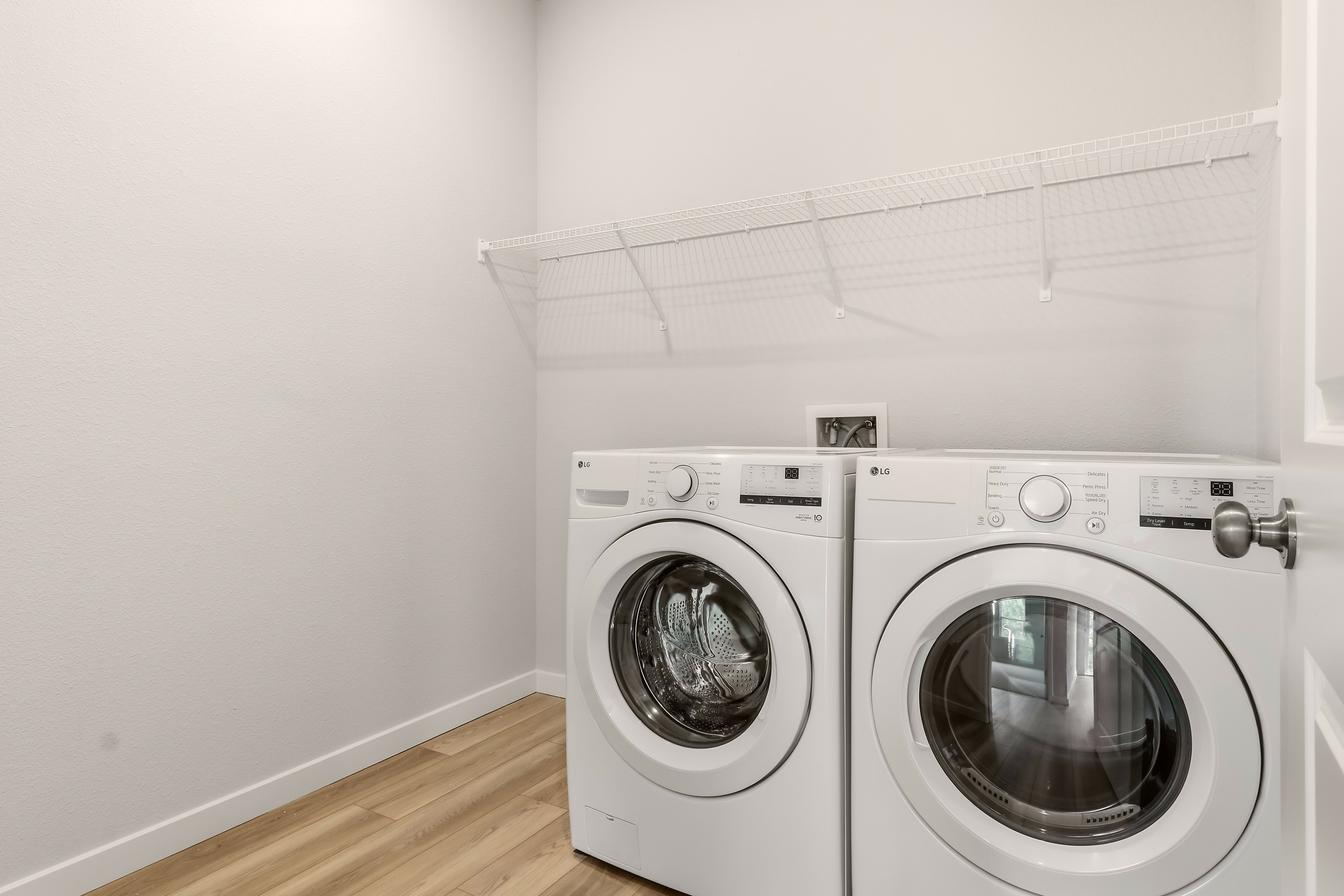 A washing machine and dryer in a room.