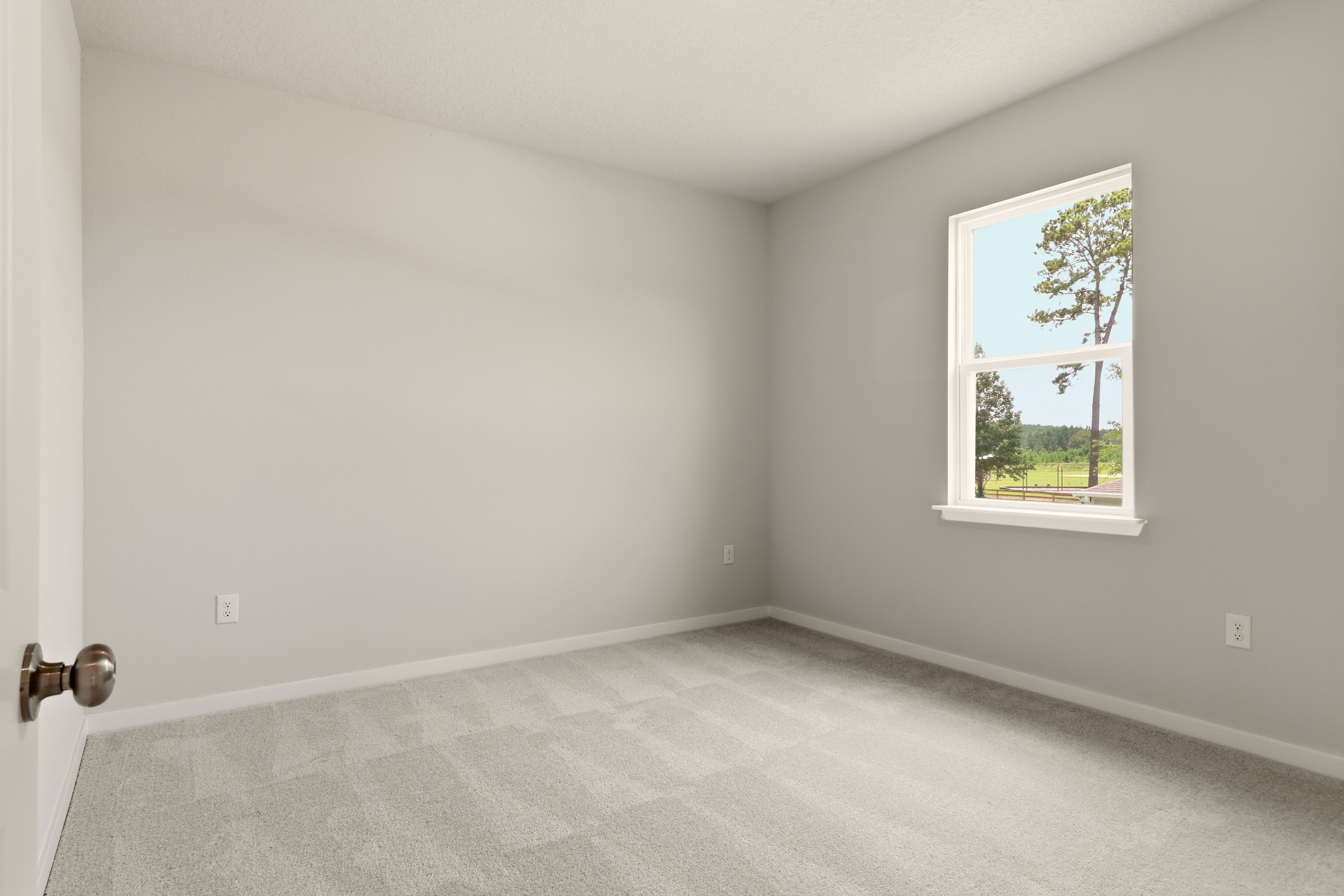 A room with a window and a door.