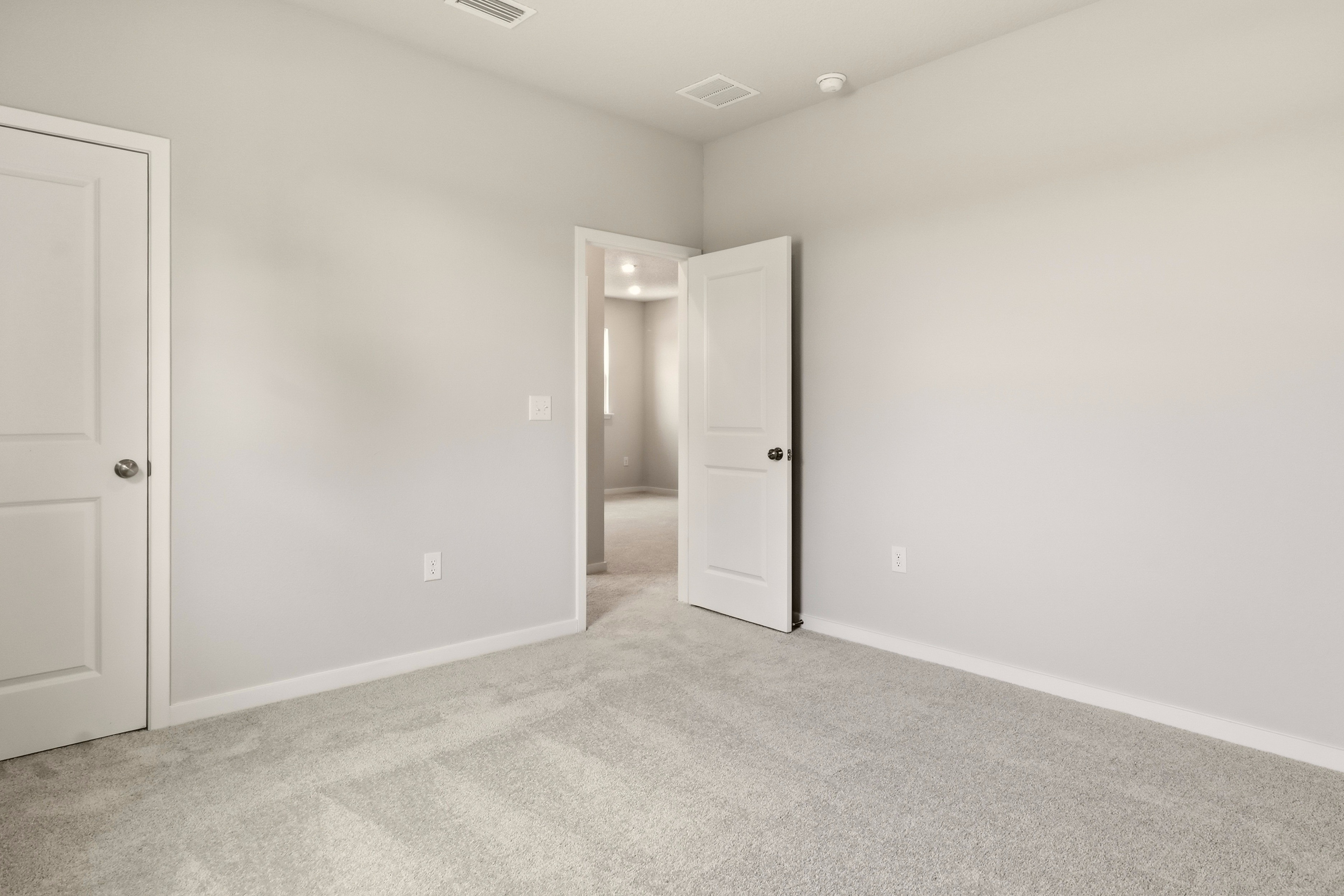 A hallway with white doors.