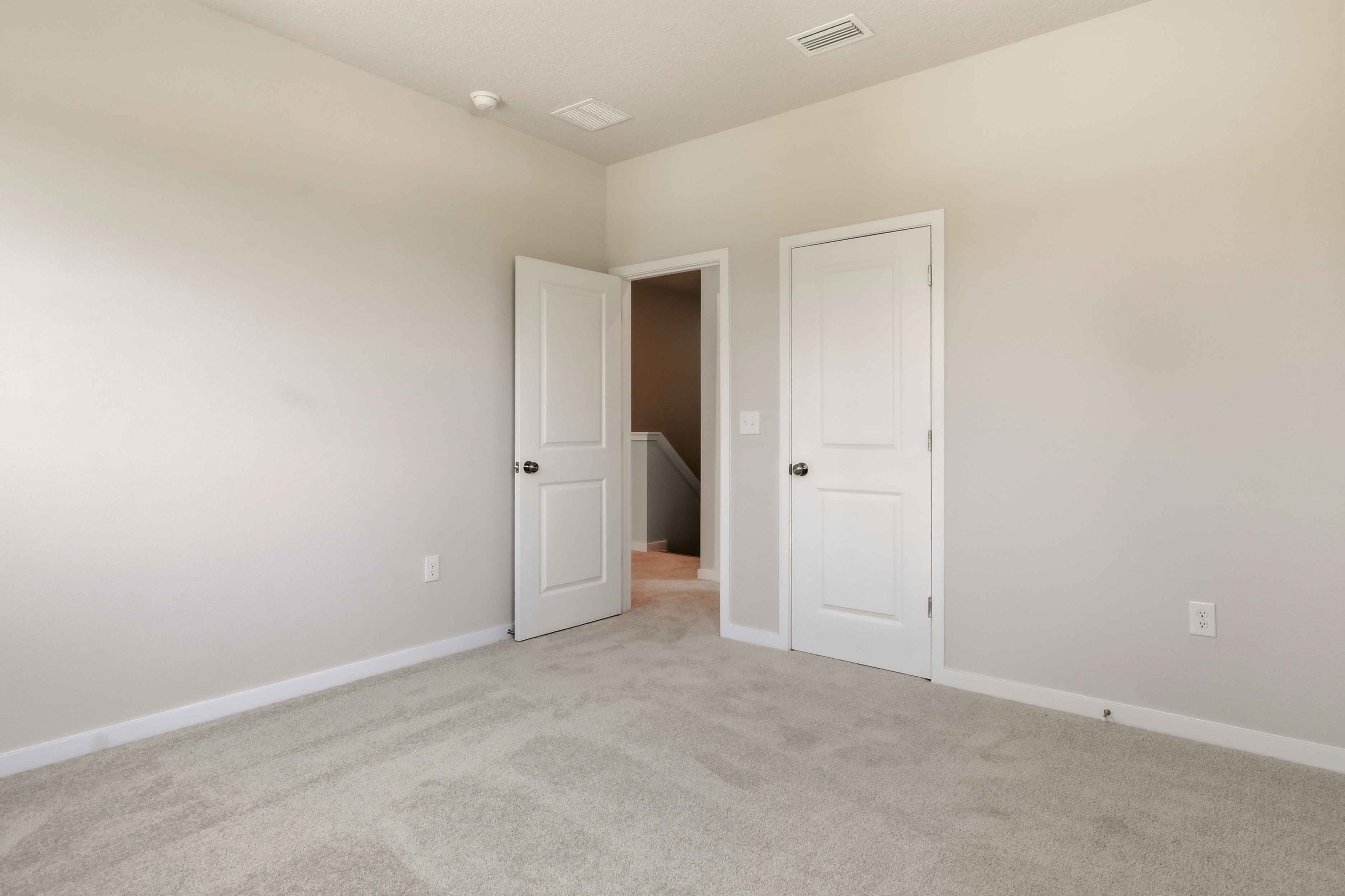 A hallway with white doors.
