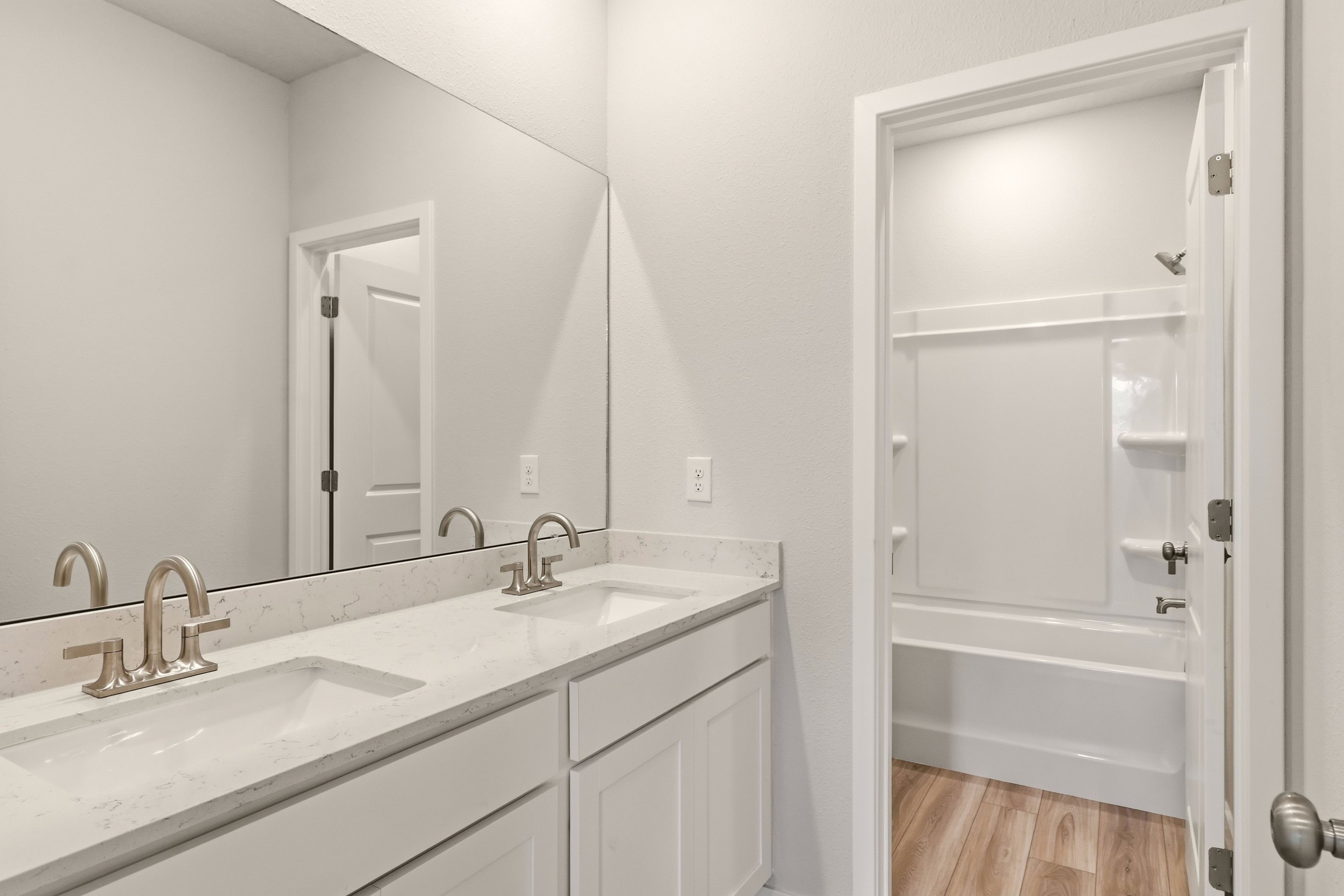 A bathroom with a sink and a mirror.