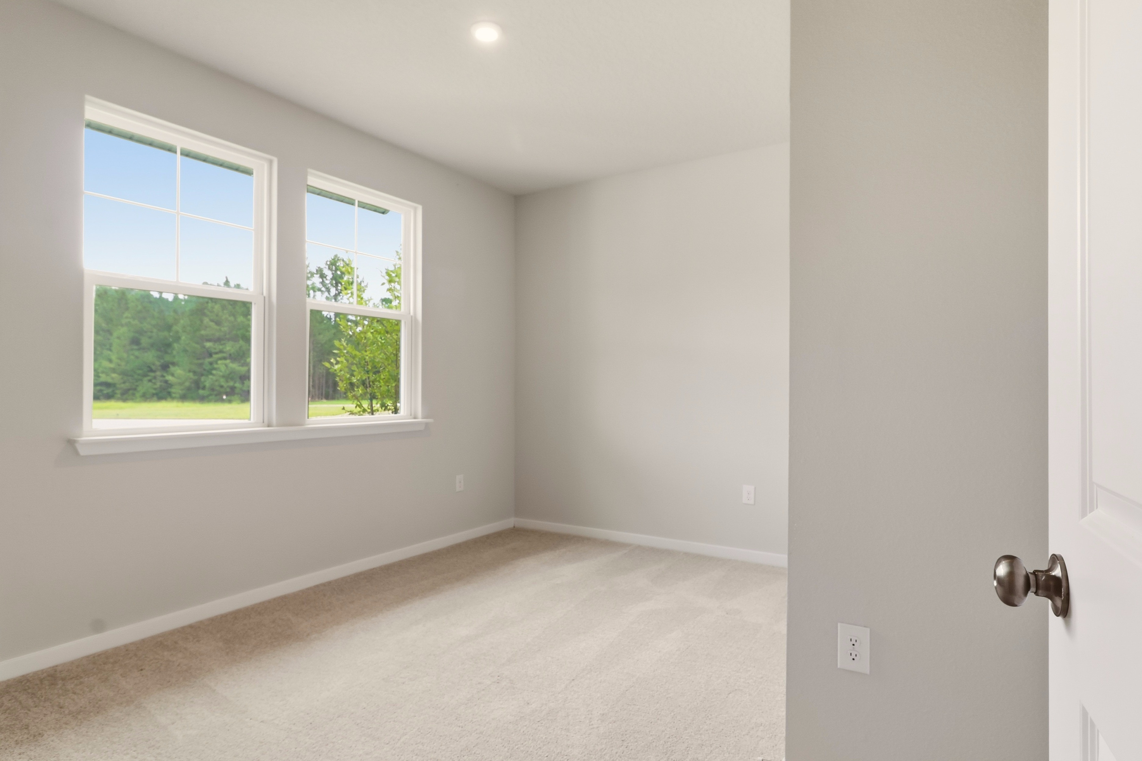A room with a window and a door.