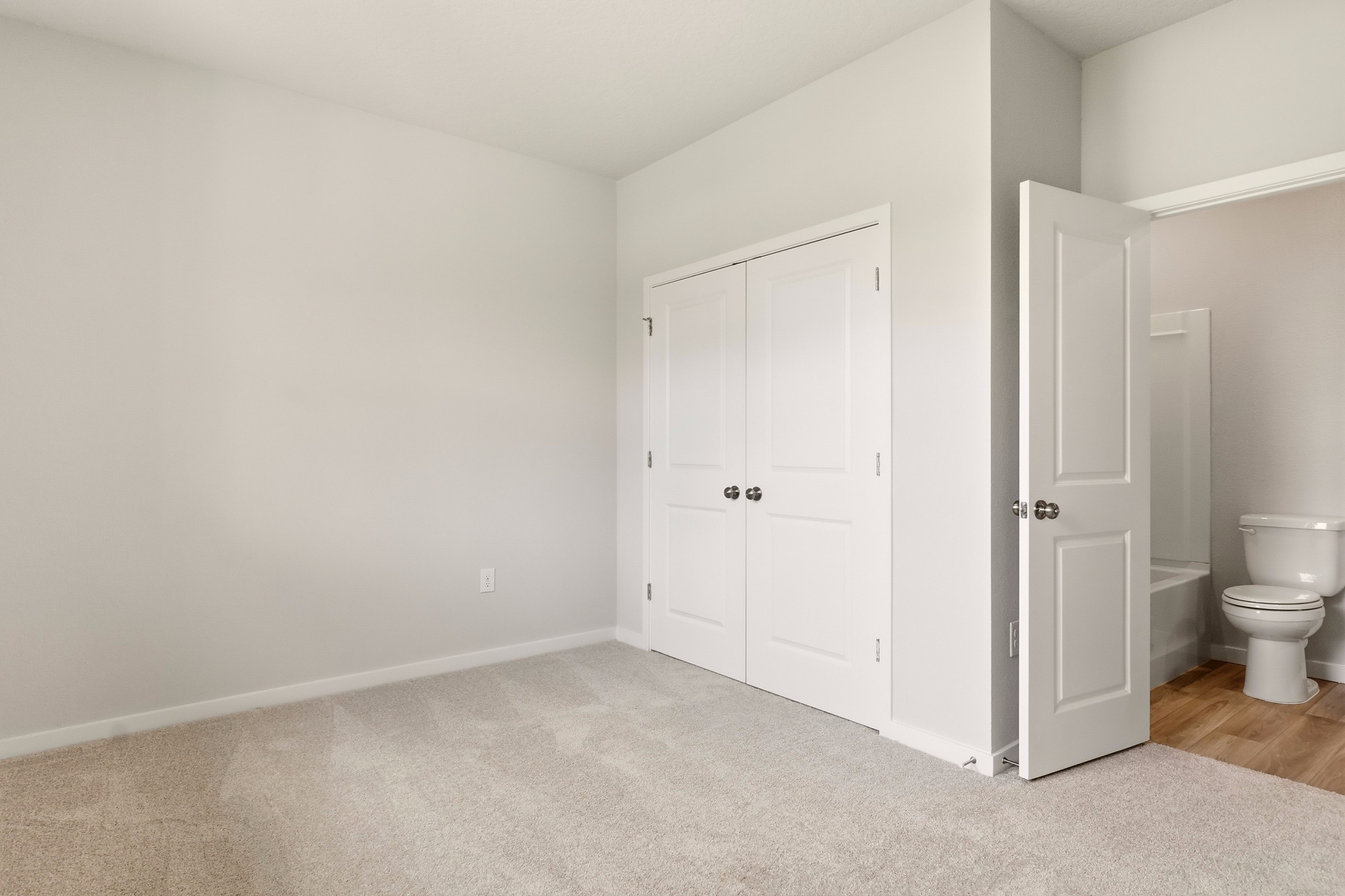 A bathroom with white doors.