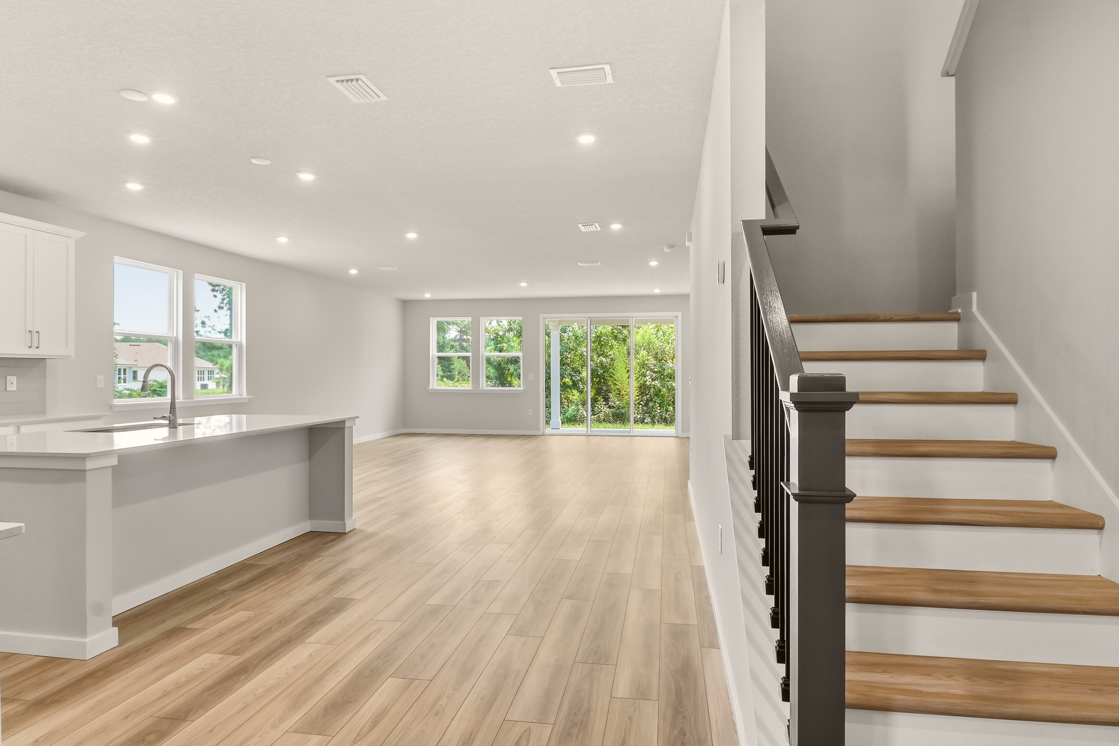 A large kitchen with a wood floor.