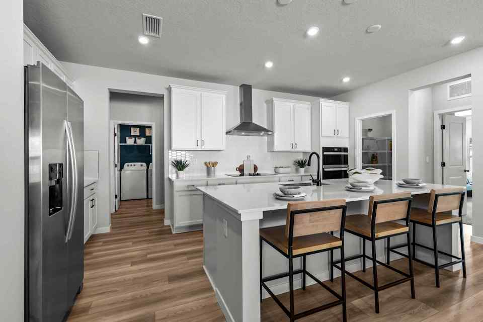 A kitchen with white cabinets.