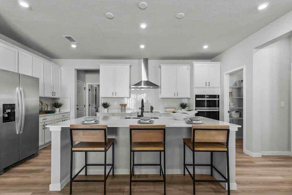 A kitchen with white cabinets.