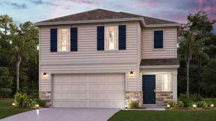 A house with a driveway and trees.