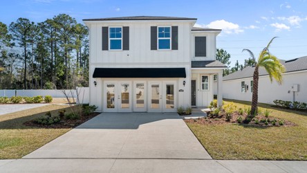 A white house with a driveway.