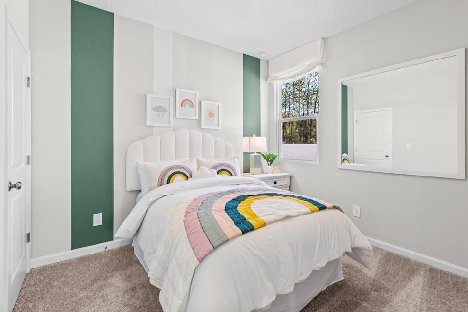 A bedroom with a bed and a window.