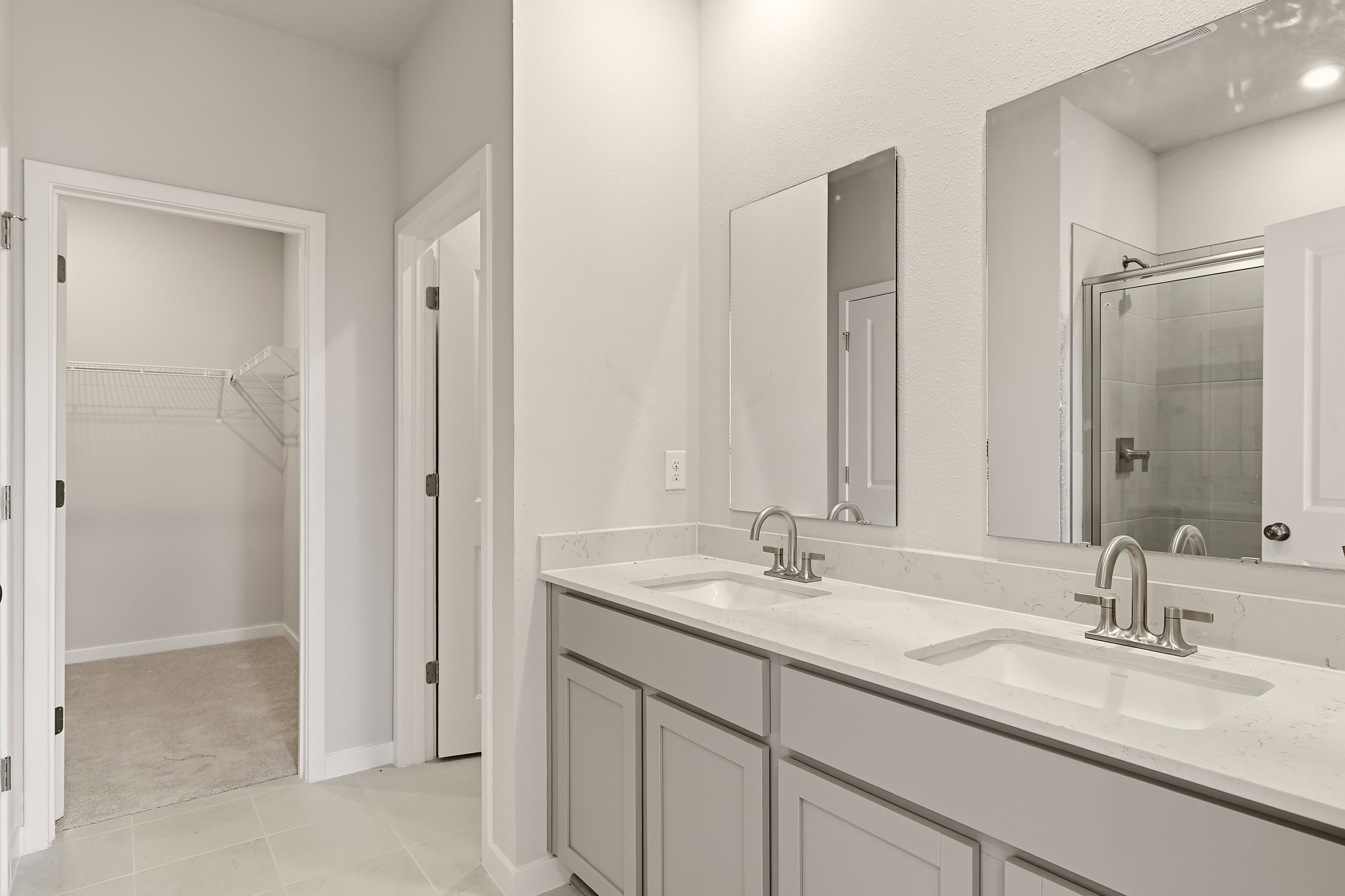 A bathroom with a sink and a shower.