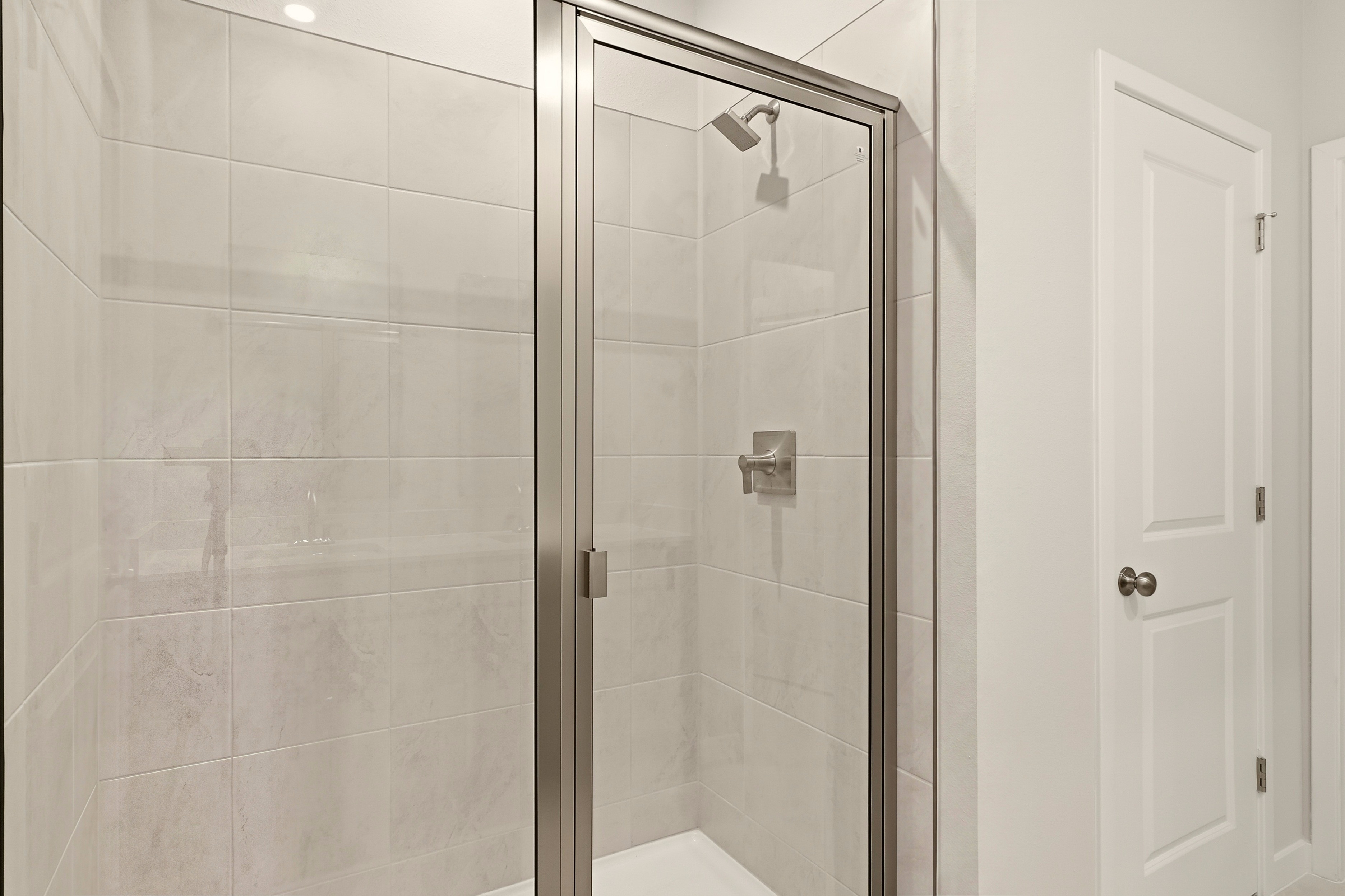A shower with a glass door.