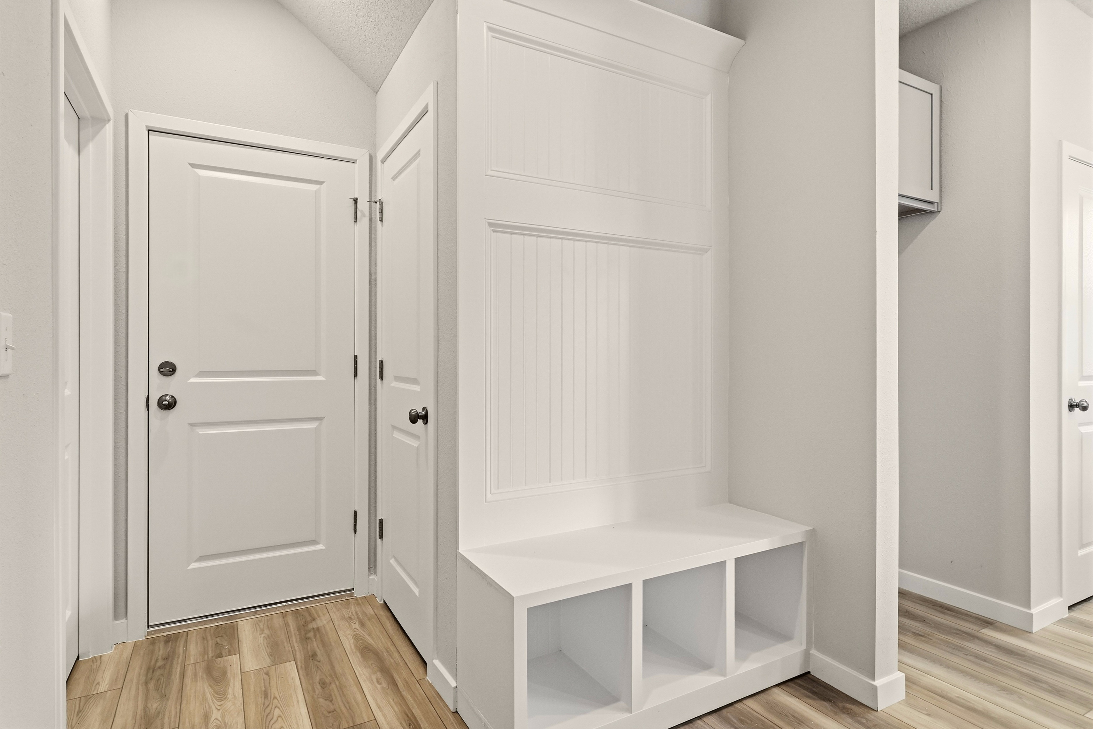 A white room with white doors.