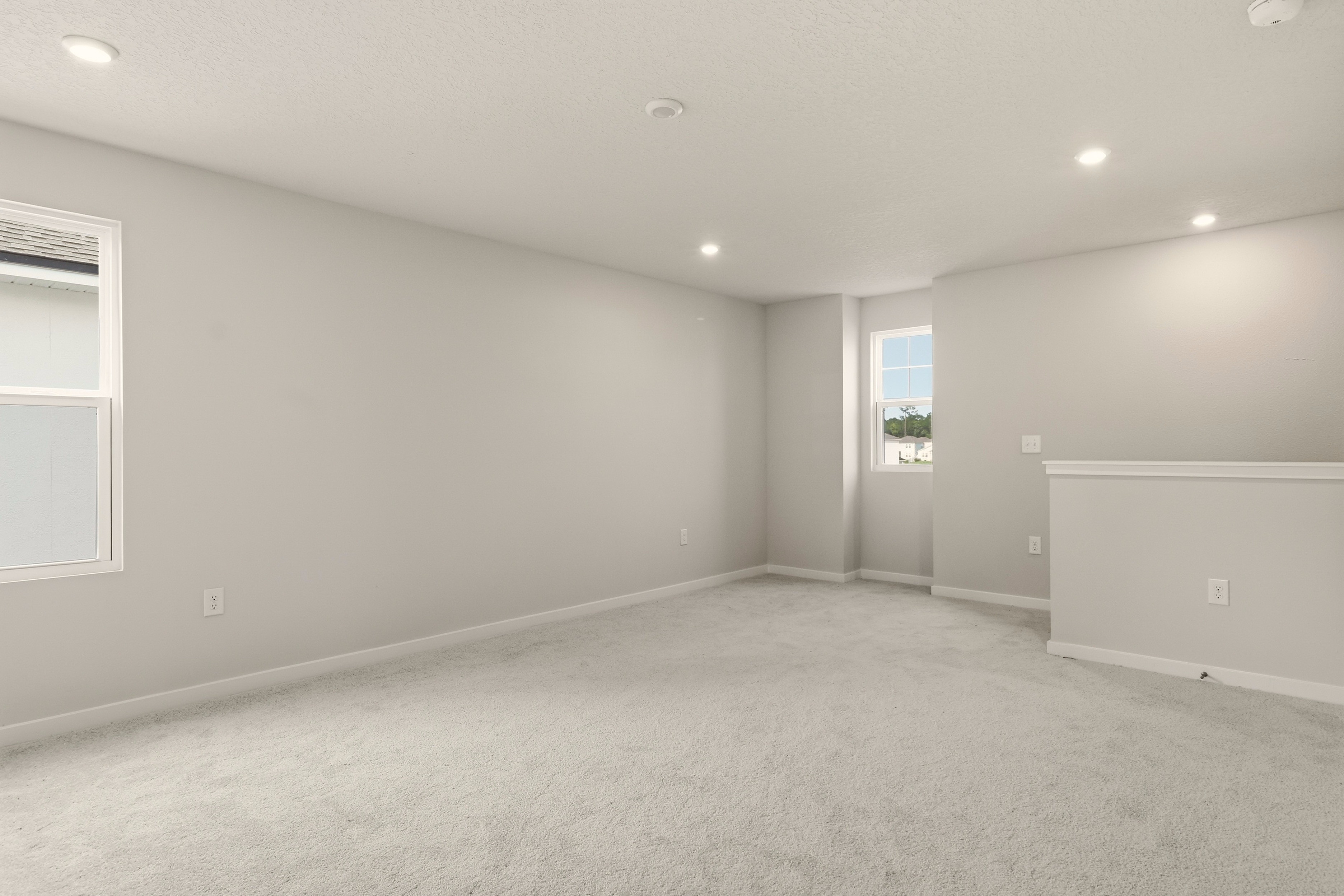 A room with a white wall and a window.