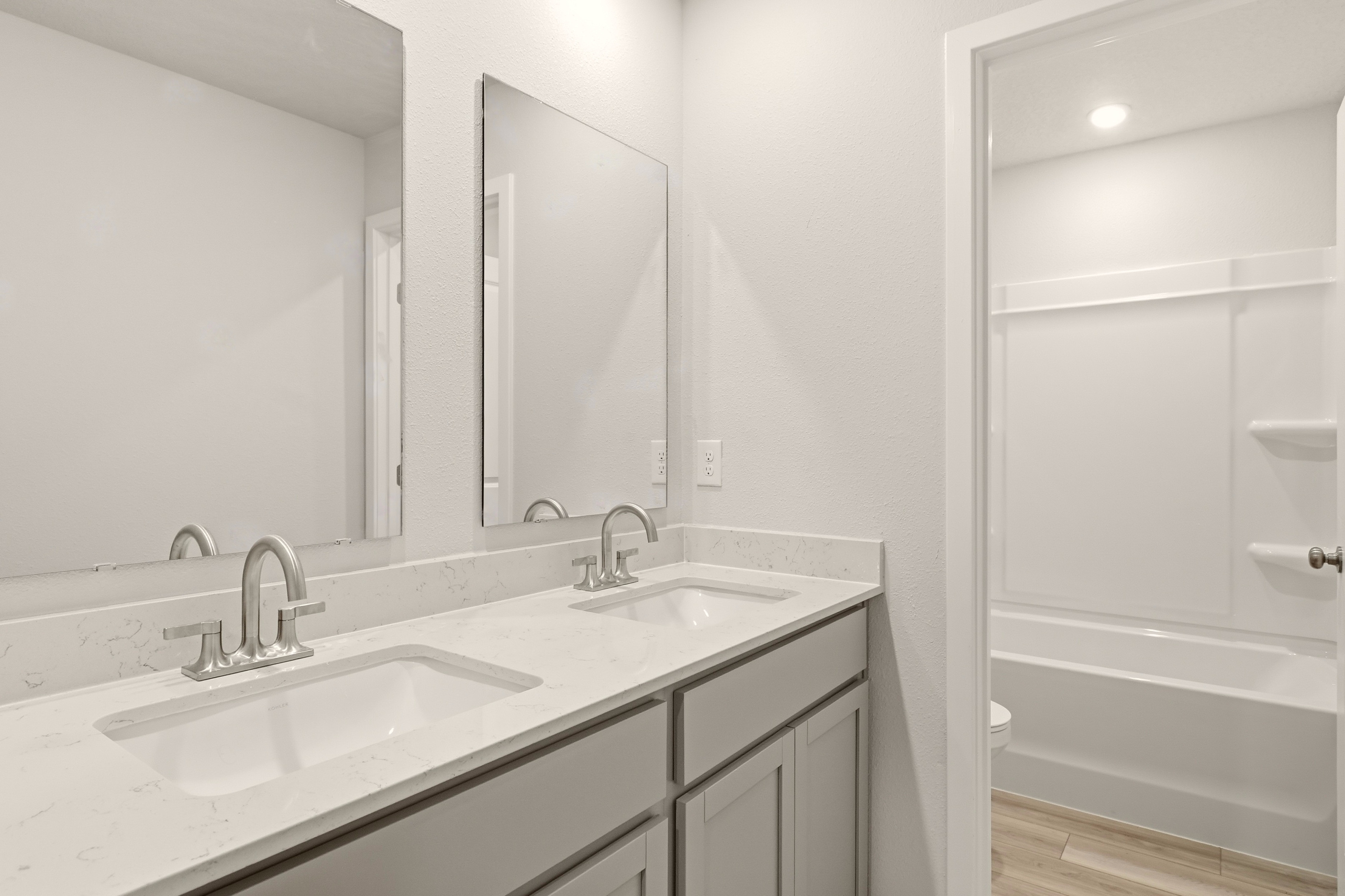 A bathroom with a sink and a mirror.