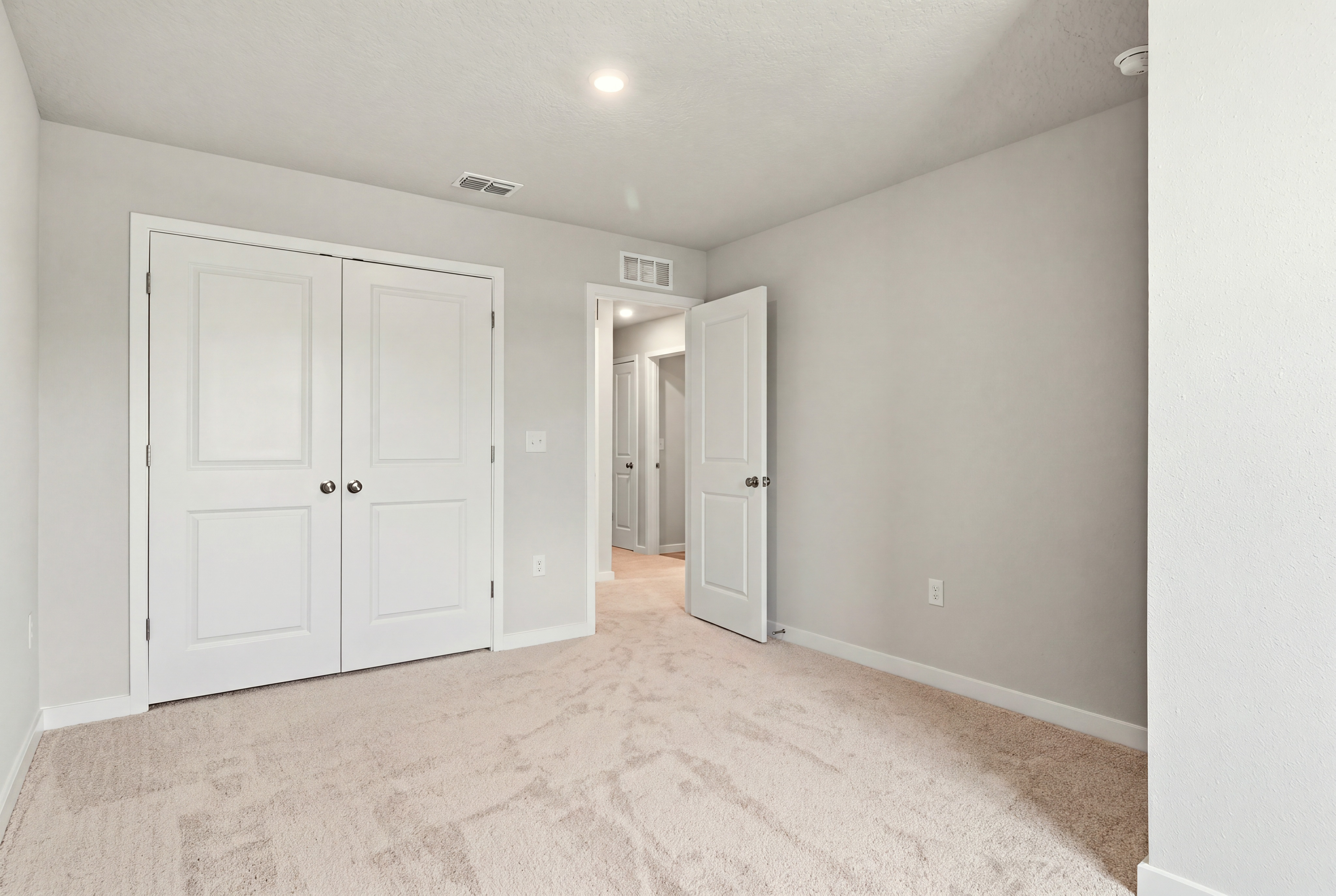 A hallway with white doors.