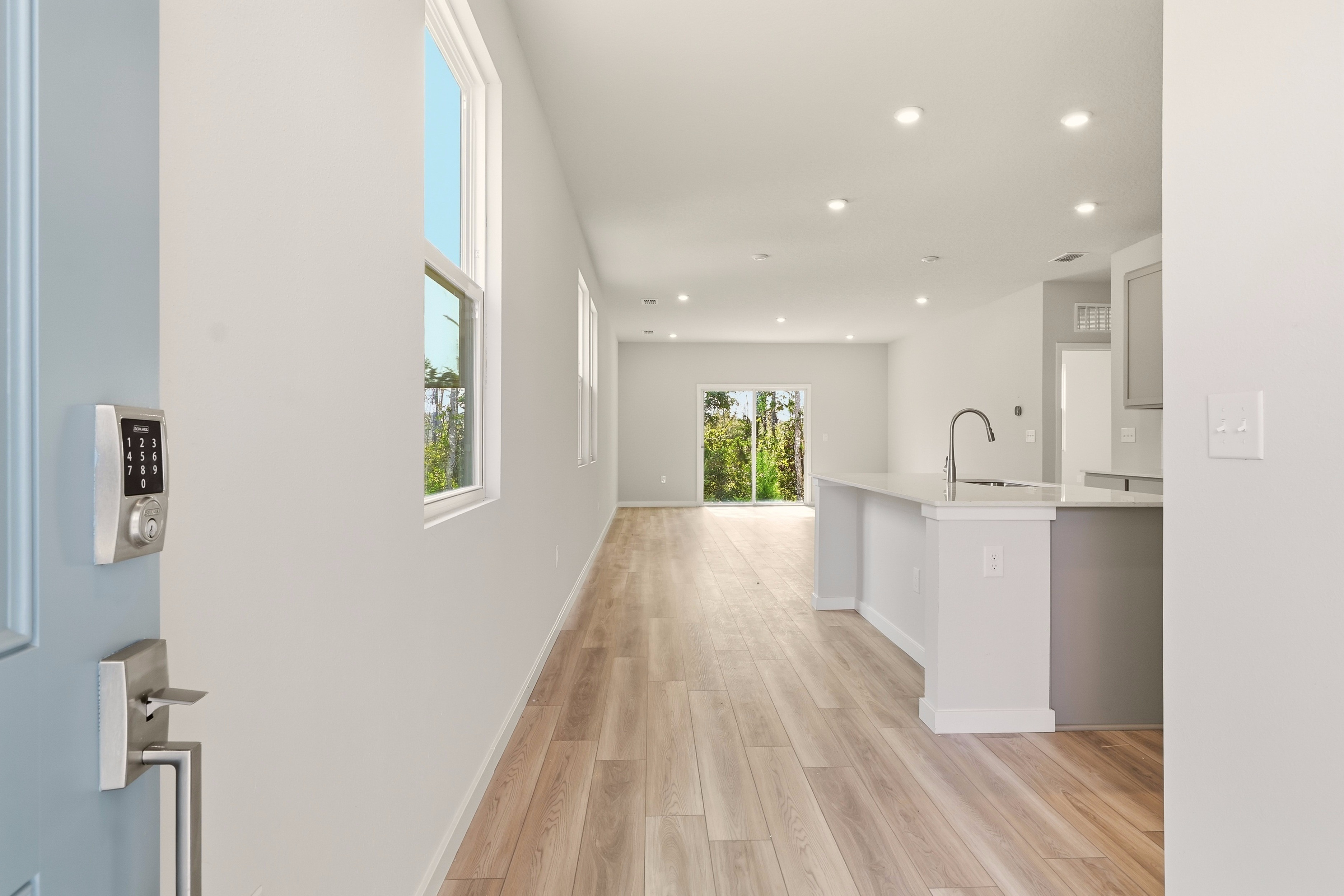 A kitchen with white cabinets.