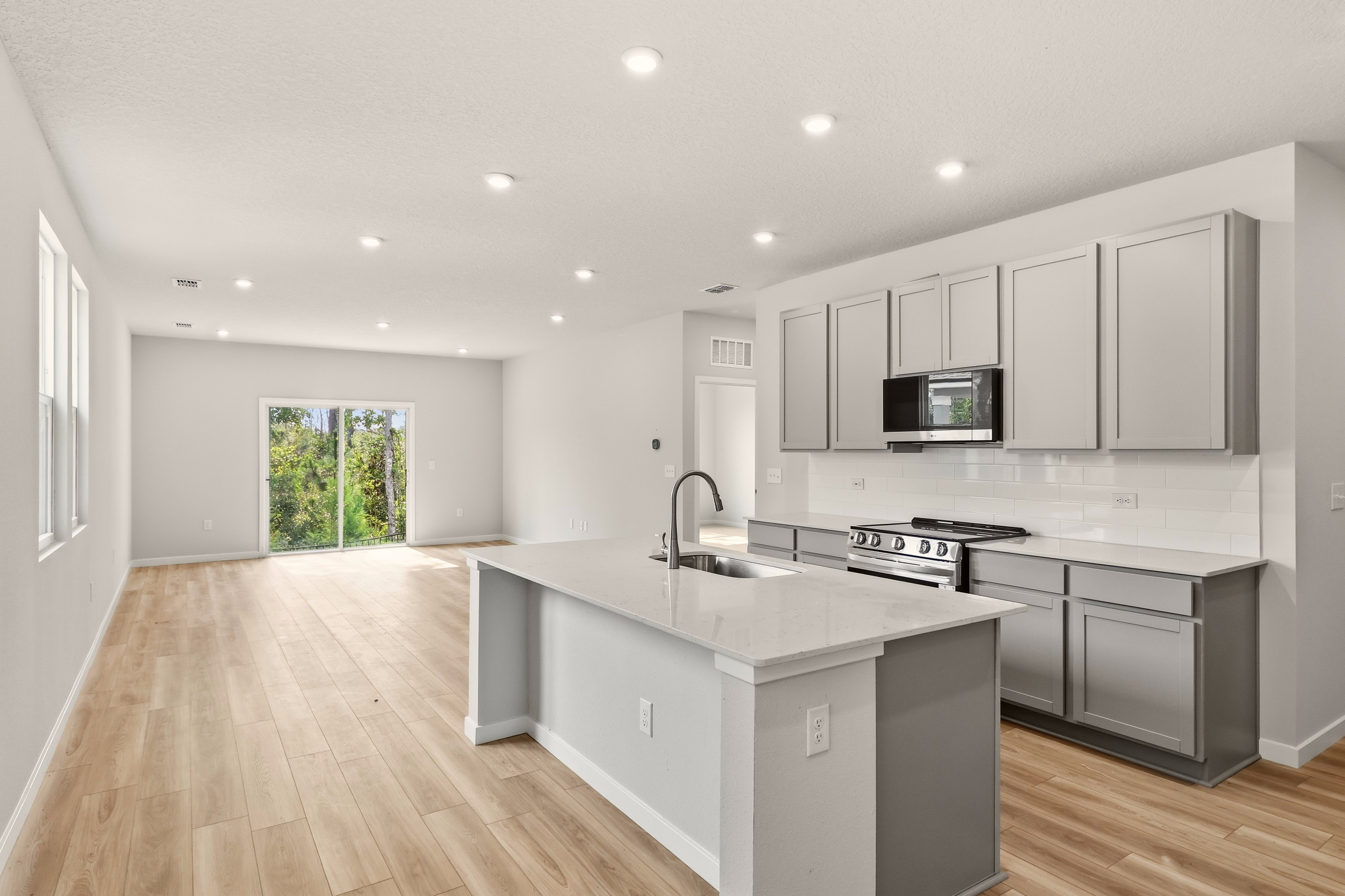 A kitchen with white cabinets.