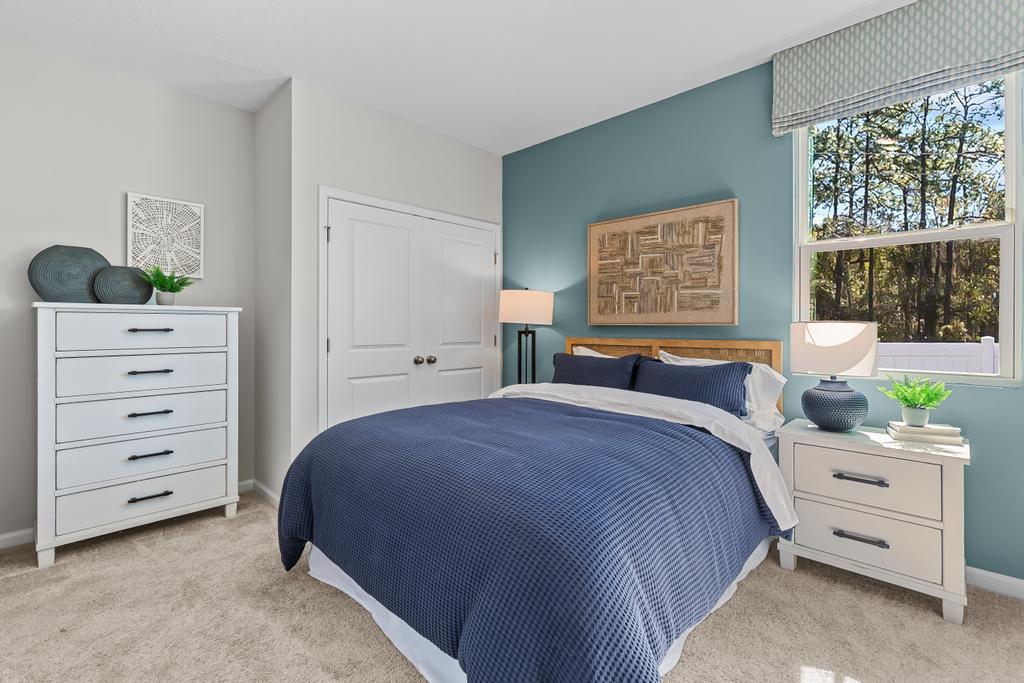 A bedroom with a blue bed.