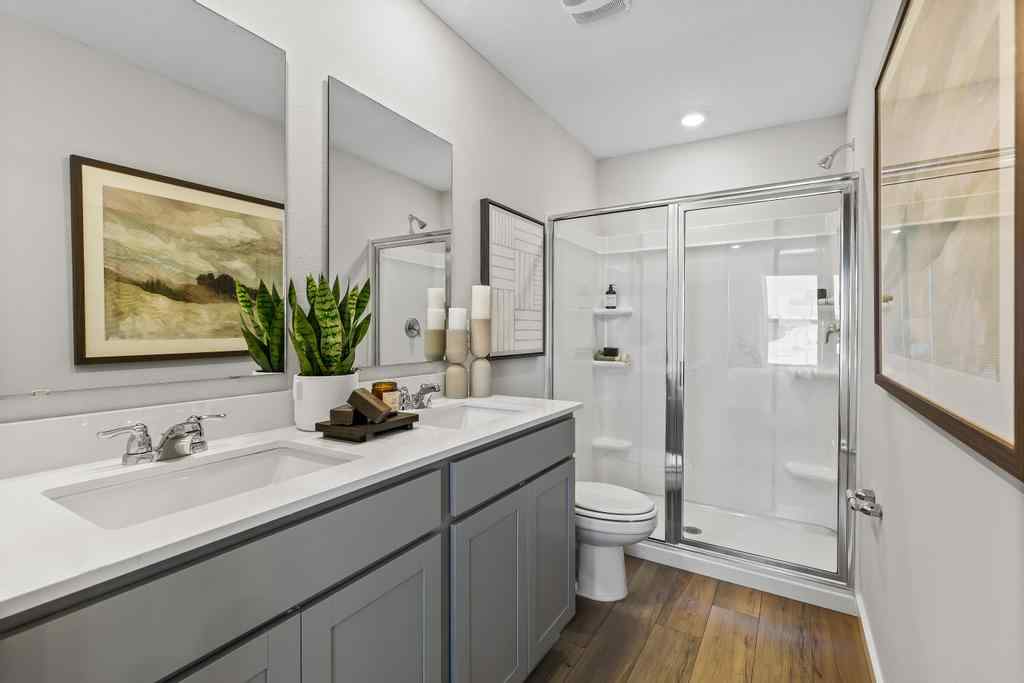 A bathroom with a sink toilet and a shower.