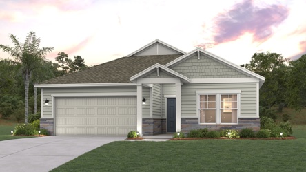 A house with a garage and trees in the back.