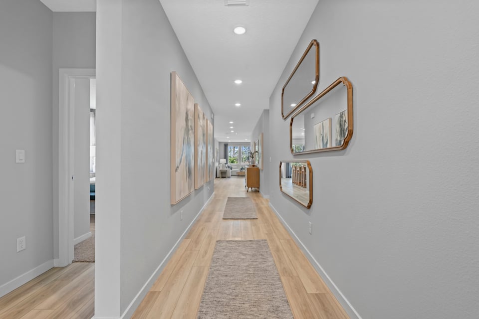 Coronado Model Home Entryway with a mirror and a rug at Reserve East in Flagler Beach