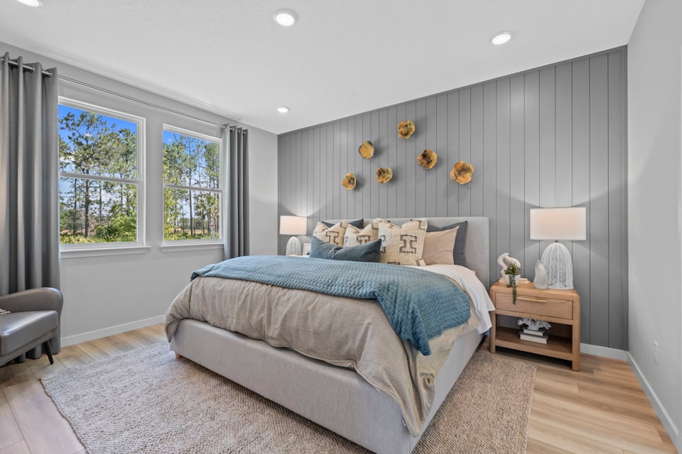 Coronado Model Home Primary Bedroom with Large Bed at Reserve East in Flagler Beach