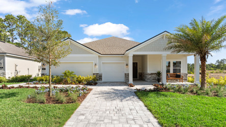 Kenai Model Home Exterior with 3 Bay Garage and Coastal Landscaping at Reserve East in Flagler Beach