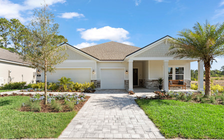 Kenai Model Home Exterior with 3 Bay Garage and Coastal Landscaping at Reserve East in Flagler Beach